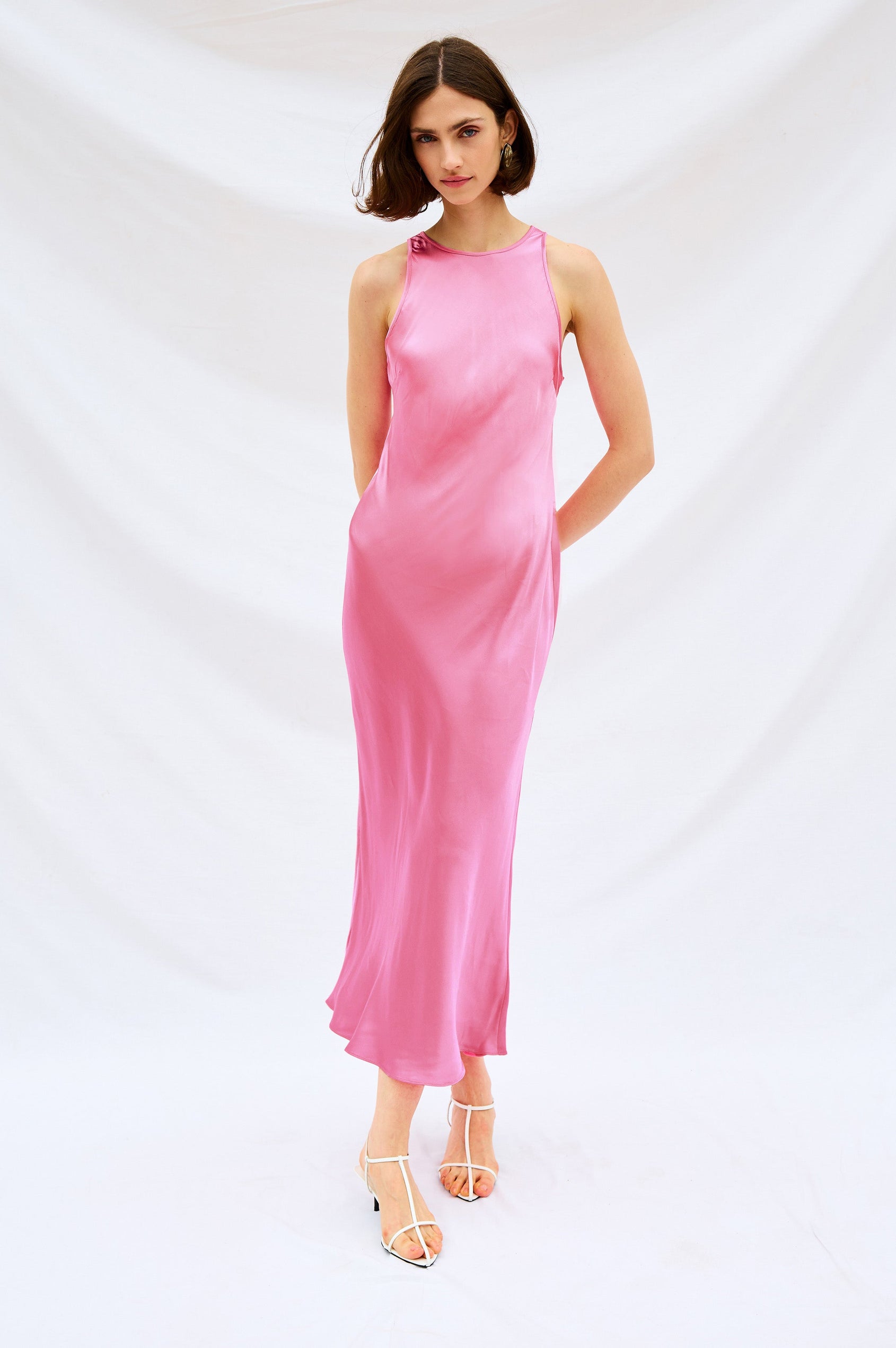Solene Sleeveless Midi Dress with a Crew Neck and a Tie Keyhole at the Back in Malibu Pink Colorway - Stylized Front Full Body View Featured on Model