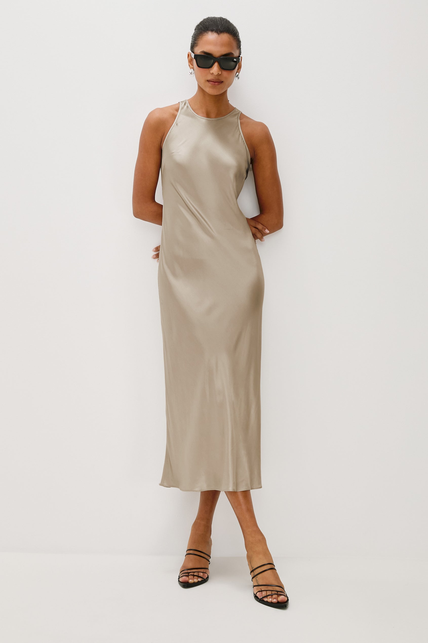 Solene Sleeveless Midi Dress with a Crew Neck and a Tie Keyhole at the Back in Mink Colorway - Front Full Body View Featured on Model wearing sunglasses
