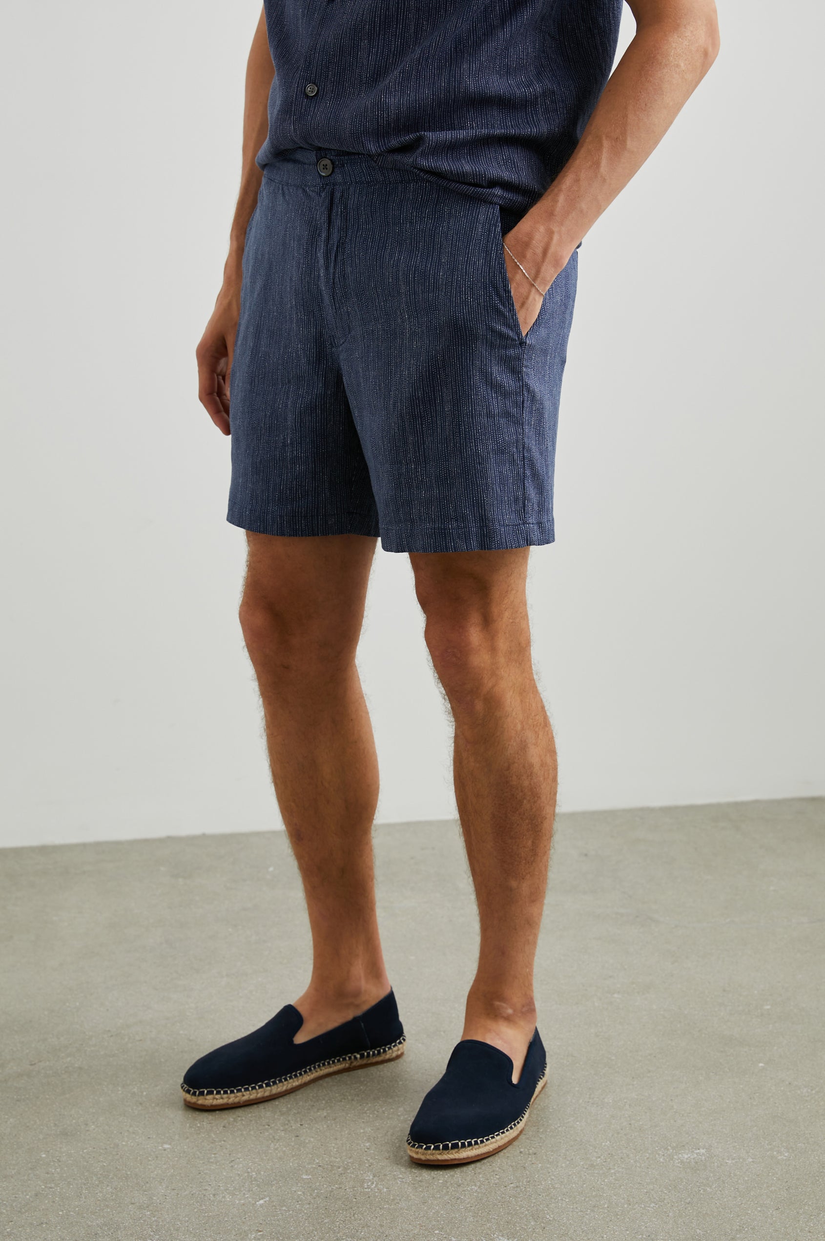 Sona Shorts with Two Front Pockets and Two Back Button Welt Pockets in Matrix Navy Pearl Colorway, Thin Pearl Dashed Vertical Lines on Navy - Front View Featured on Model 