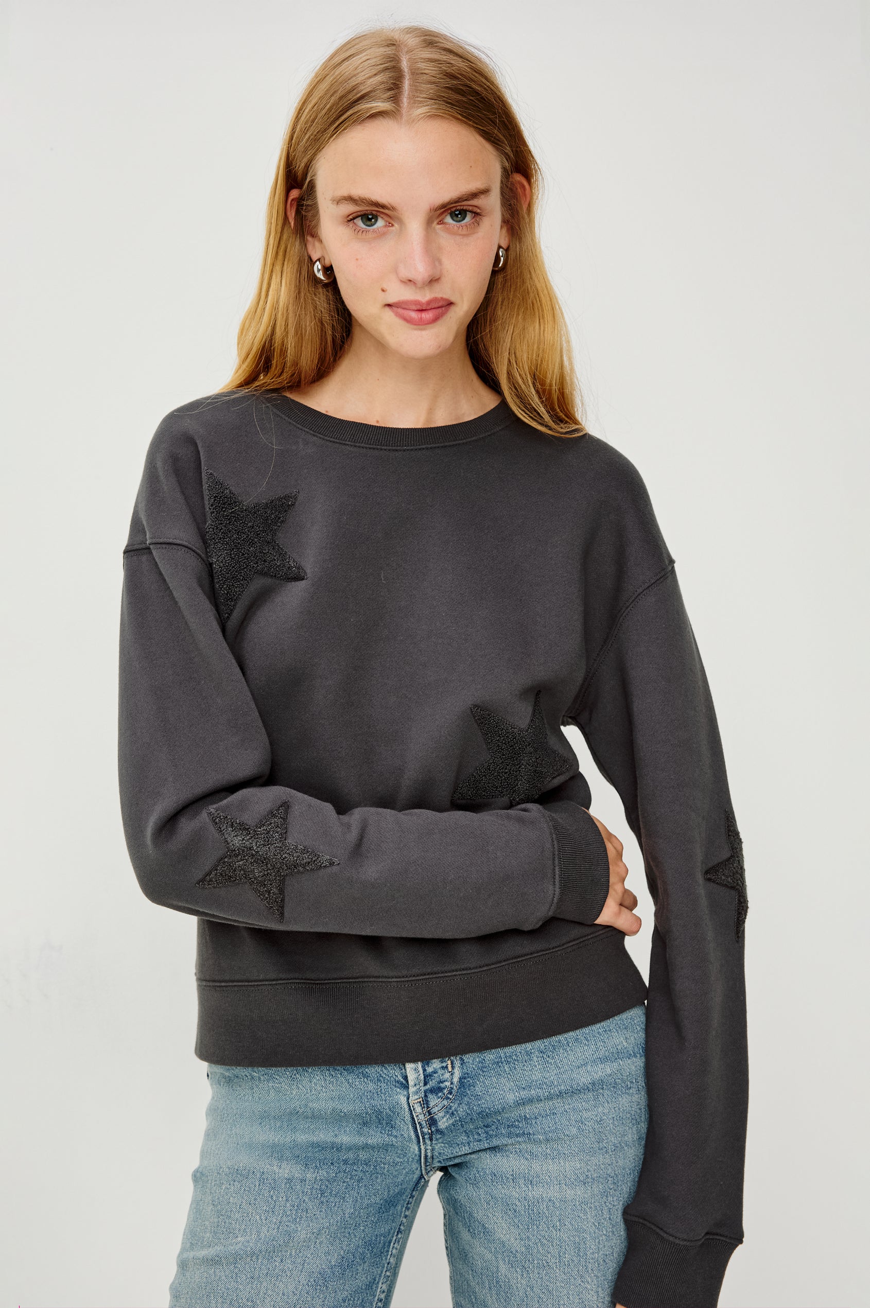 Sonia Long-Sleeve Sweatshirt with a Crew Neck and Charcoal Patch Stars in Washed Black Colorway - Front View Featured on Model