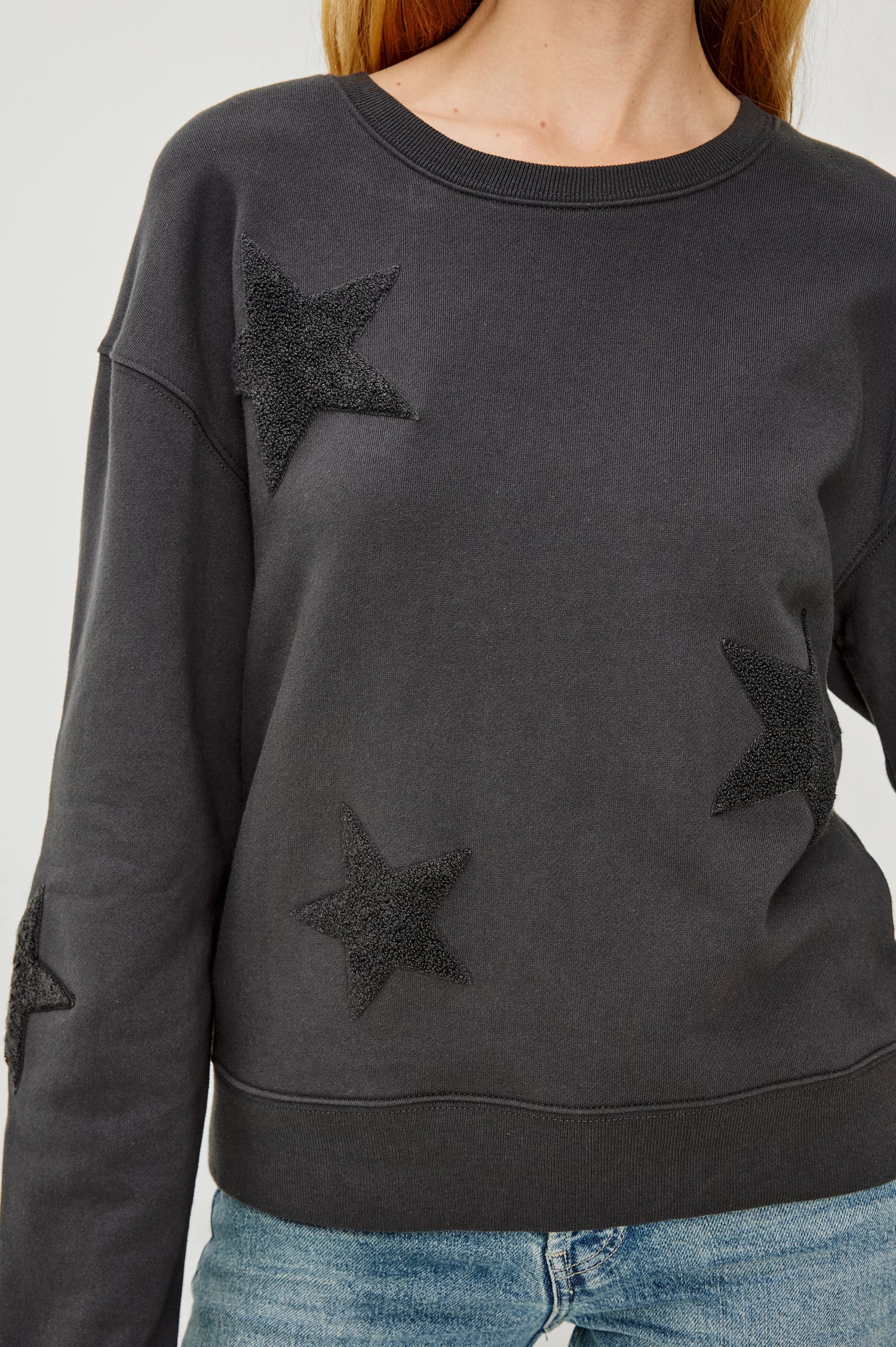 Sonia Long-Sleeve Sweatshirt with a Crew Neck and Charcoal Patch Stars in Washed Black Colorway - Close UP View Featured on Model