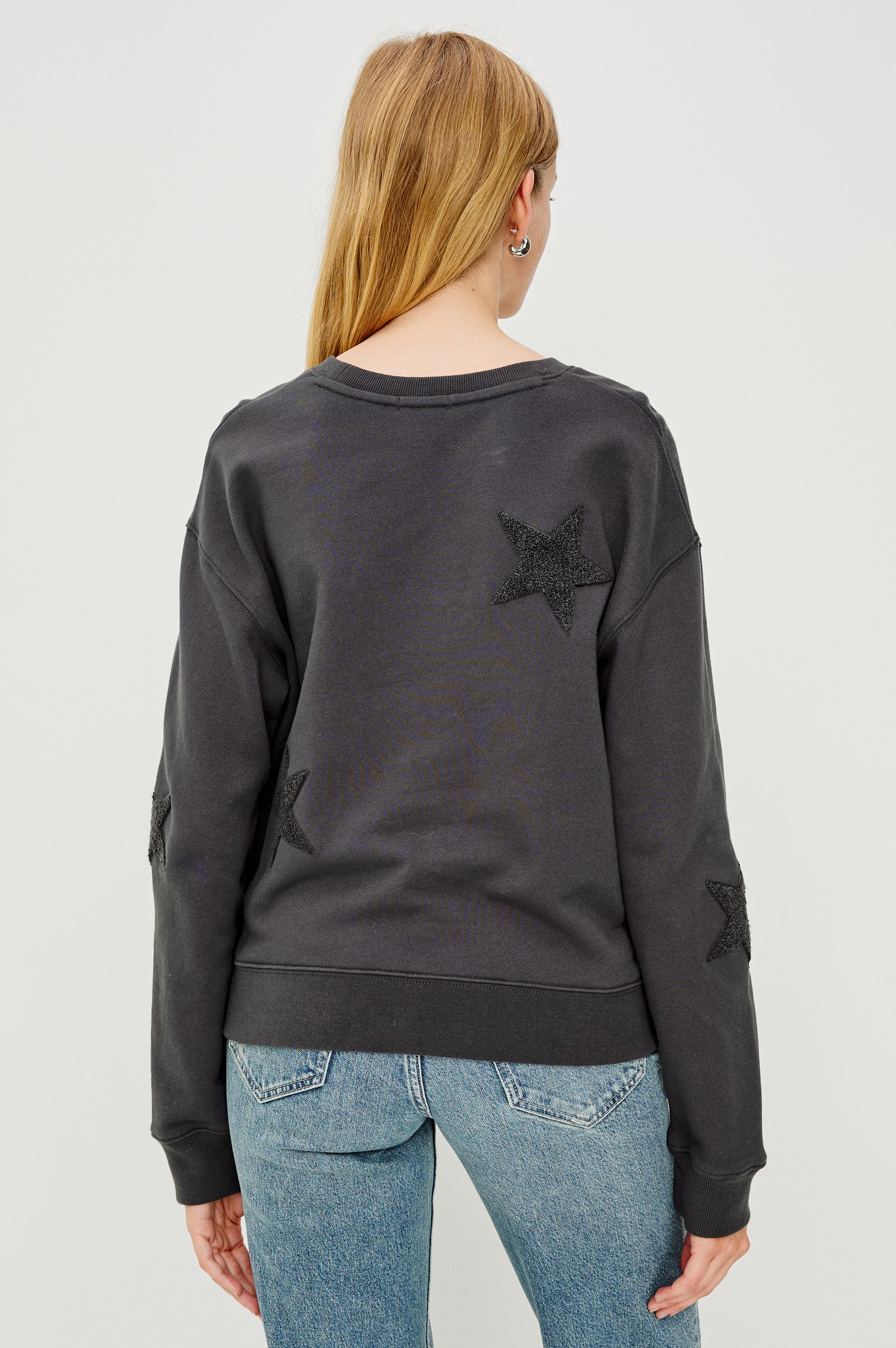 Sonia Long-Sleeve Sweatshirt with a Crew Neck and Charcoal Patch Stars in Washed Black Colorway - Back View Featured on Model