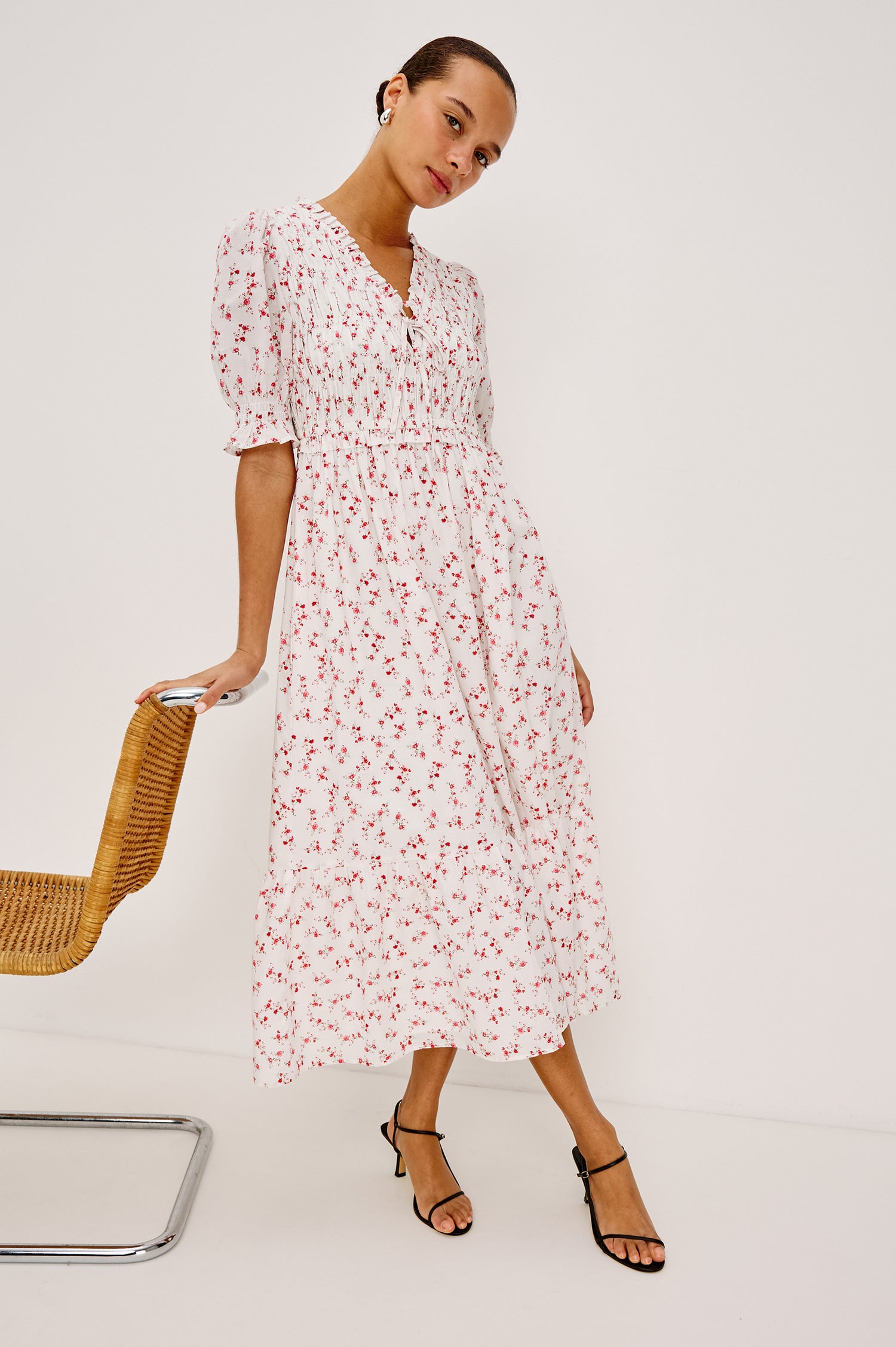 Sonica Midi Dress in Cotton With Fitted Smocked Bodice Plunging V-Neckline With Self-Ties Short Puff Sleeves and Single Tiered A-Line Skirt in Rouge Romantic Colorway - Full Body Front View Featured on Model