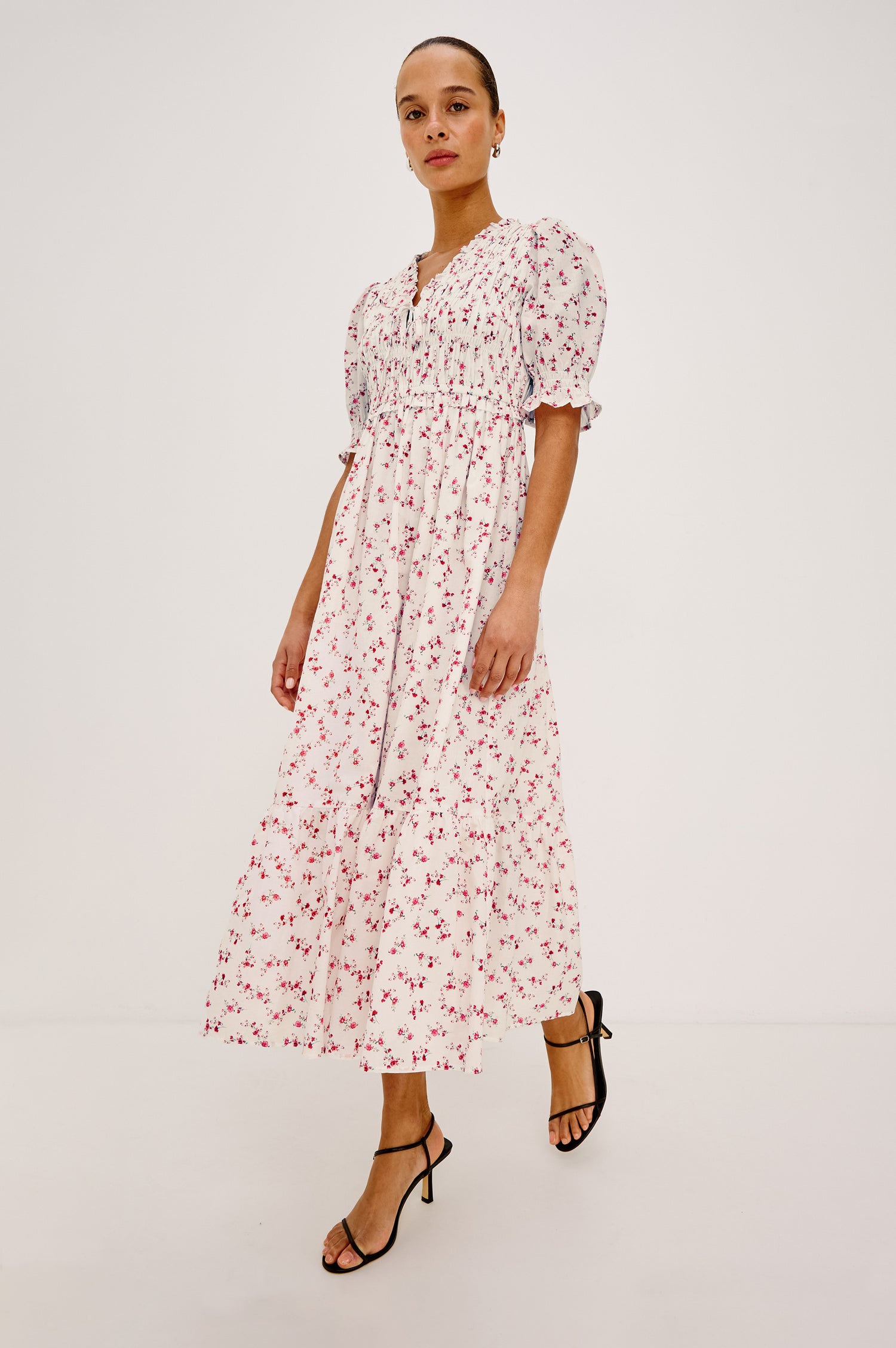 Sonica Midi Dress in Cotton With Fitted Smocked Bodice Plunging V-Neckline With Self-Ties Short Puff Sleeves and Single Tiered A-Line Skirt in Rouge Romantic Colorway - Upper Body Close Up View Featured on Model