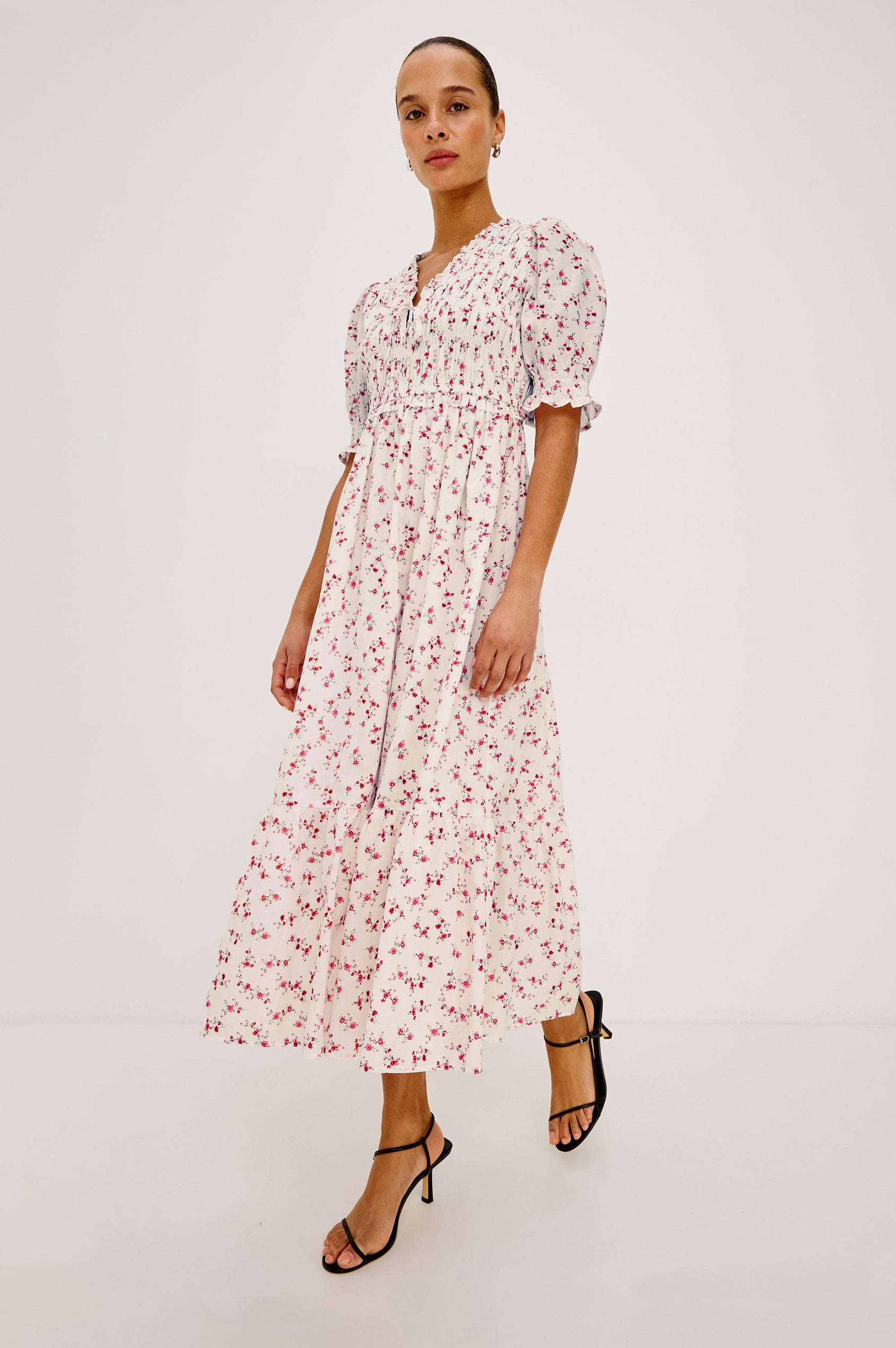 Sonica Midi Dress in Cotton With Fitted Smocked Bodice Plunging V-Neckline With Self-Ties Short Puff Sleeves and Single Tiered A-Line Skirt in Rouge Romantic Colorway - Upper Body Close Up View Featured on Model
