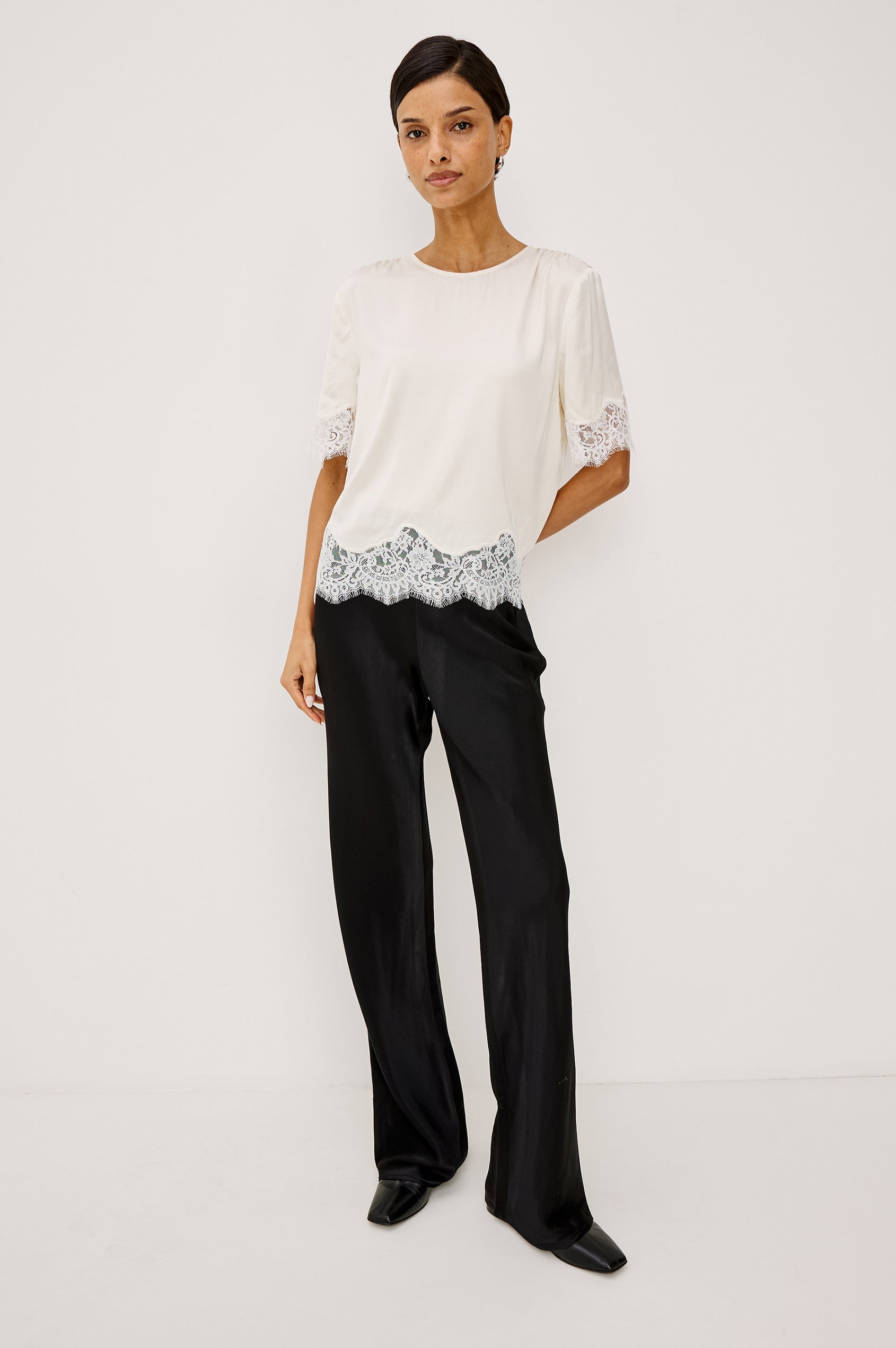 Sonora Shirt in Satin Blend With Loose Boxy Fit, Crew Neck, Shirred Shoulders, Short Sleeves, Button-Loop Back Keyhole, and Lace Trim in Ivory Colorway - Full Body Front View Featured on Model