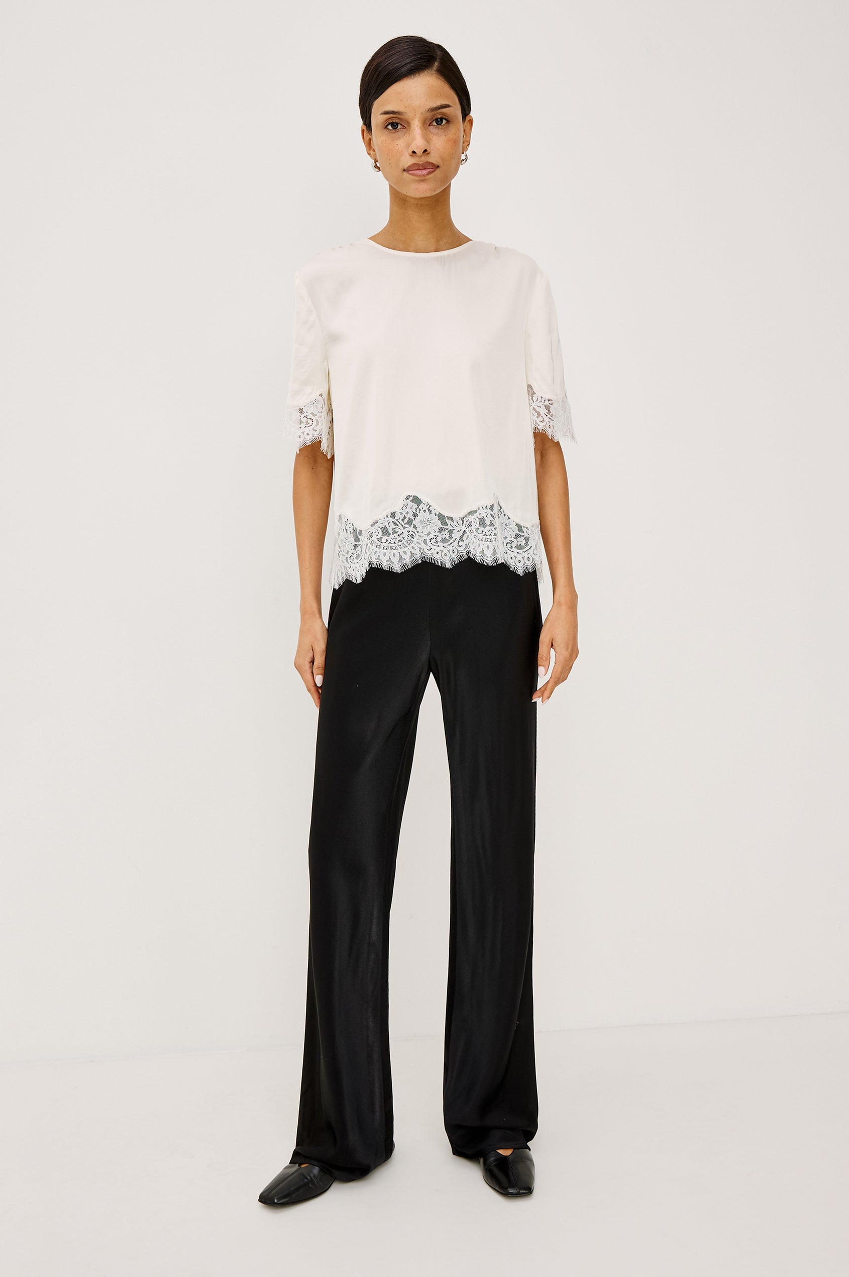Sonora Shirt in Satin Blend With Loose Boxy Fit, Crew Neck, Shirred Shoulders, Short Sleeves, Button-Loop Back Keyhole, and Lace Trim in Ivory Colorway - Full Body Front View Featured on Model