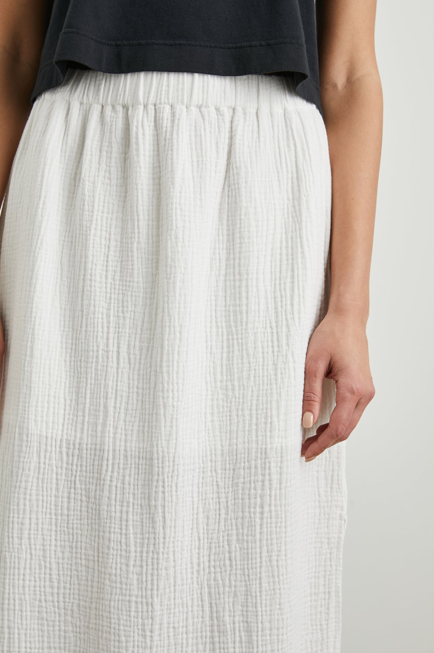 Soraya Midi Skirt with a Side Slit and Lined to the Mid-Thigh in White Colorway - Front View Featured on Model 