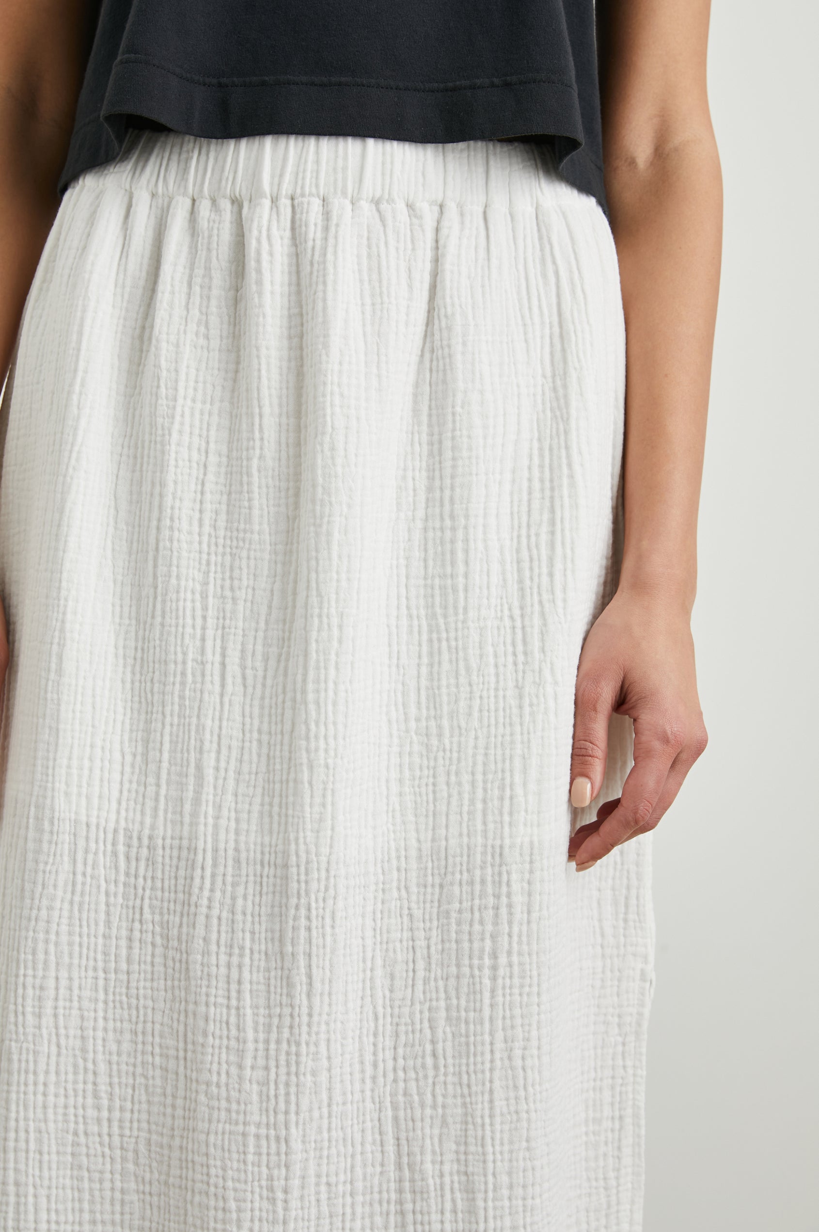 Soraya Midi Skirt with a Side Slit and Lined to the Mid-Thigh in White Colorway - Front View Featured on Model 