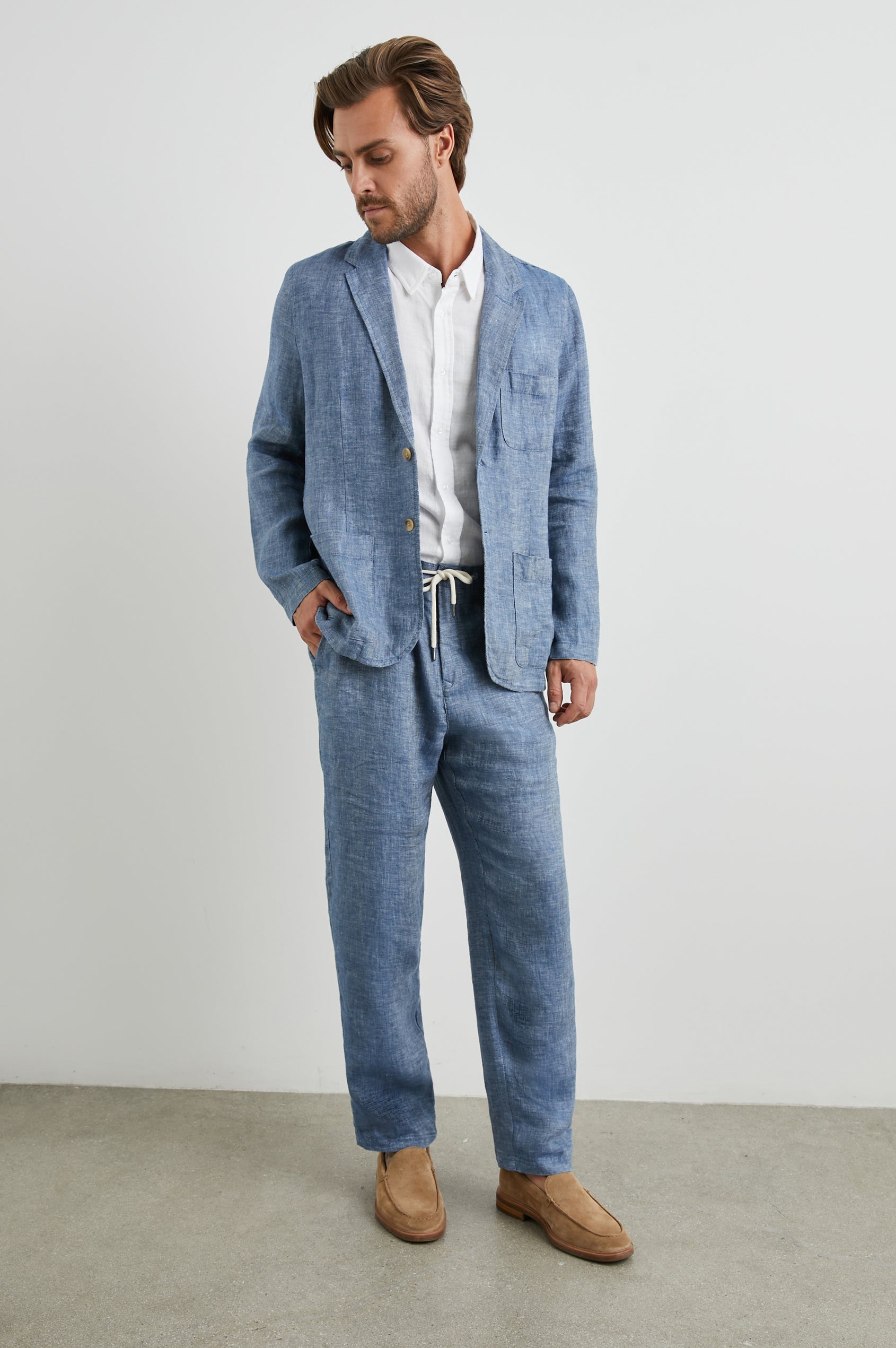 Mercer Pants with a Button and Drawcord Waist, Belt Loops, Two Front Pockets and Two Back Button Welt Pockets in Blue Mirage Colorway - Front Full Body View Featured on Model