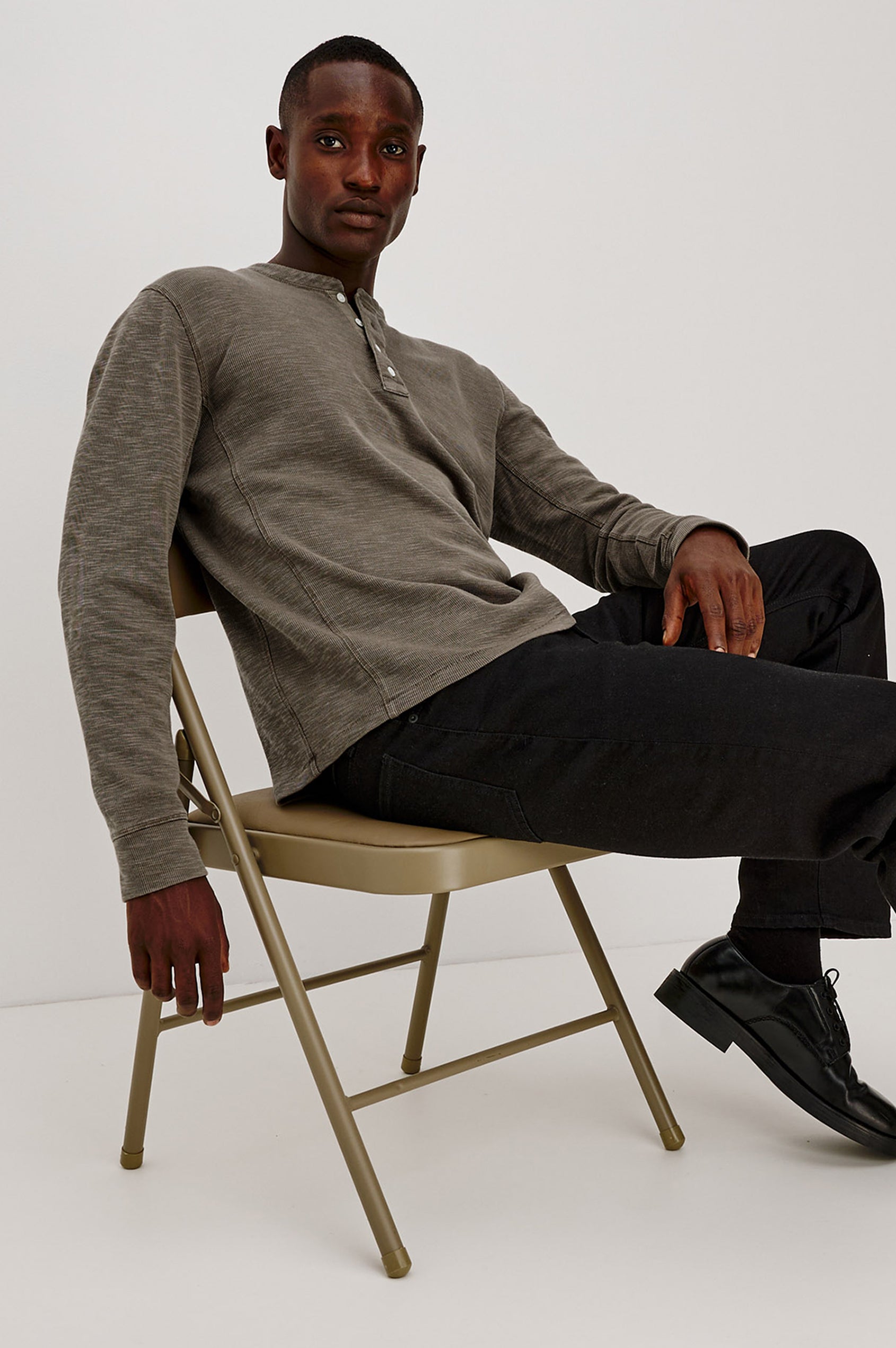 Soto Henley in Cotton French Rib Blend With 4-Button Placket, Tonal Seam Detailing, and Long Sleeves in Crossroad Colorway - Full Body View Featured on Model Sitting
