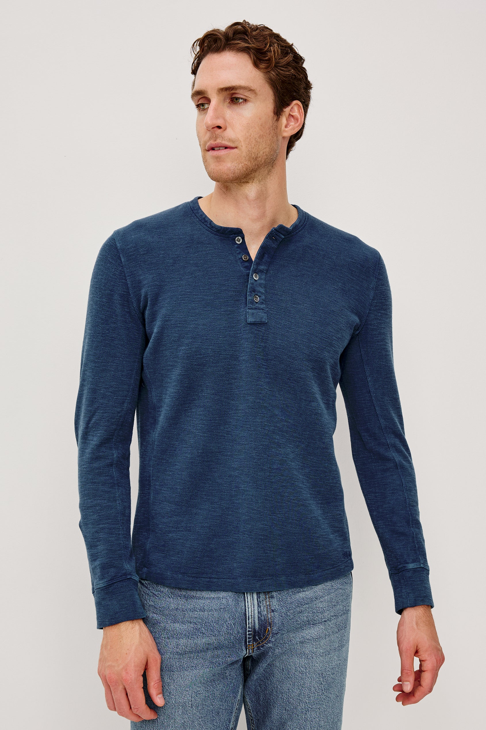 Soto Long-Sleeve Henley with a Four Button Placket and a Crew Neck in Vintage Indigo Colorway - Front Full Body View Featured on Model