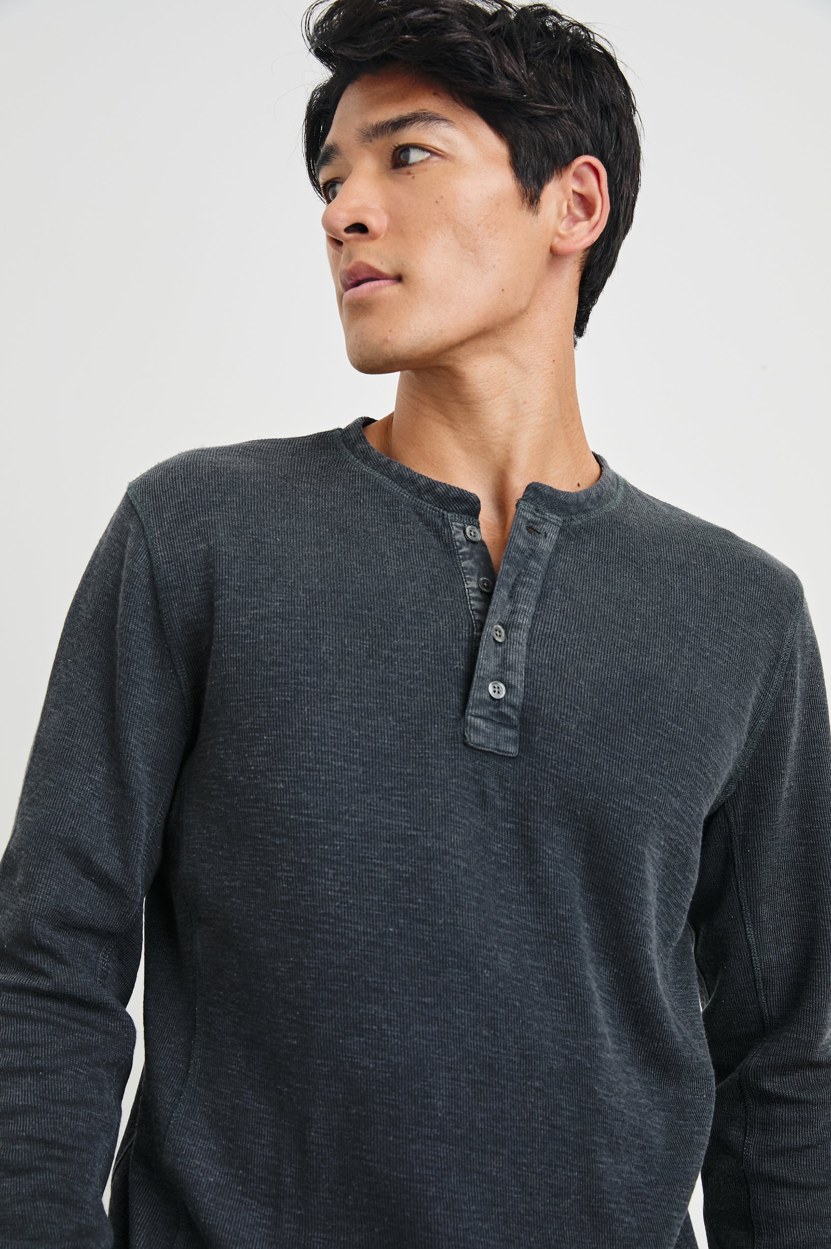 Soto Long-Sleeve Henley with a Four Button Placket and a Crew Neck in Washed Black Colorway - Front View Featured on Model