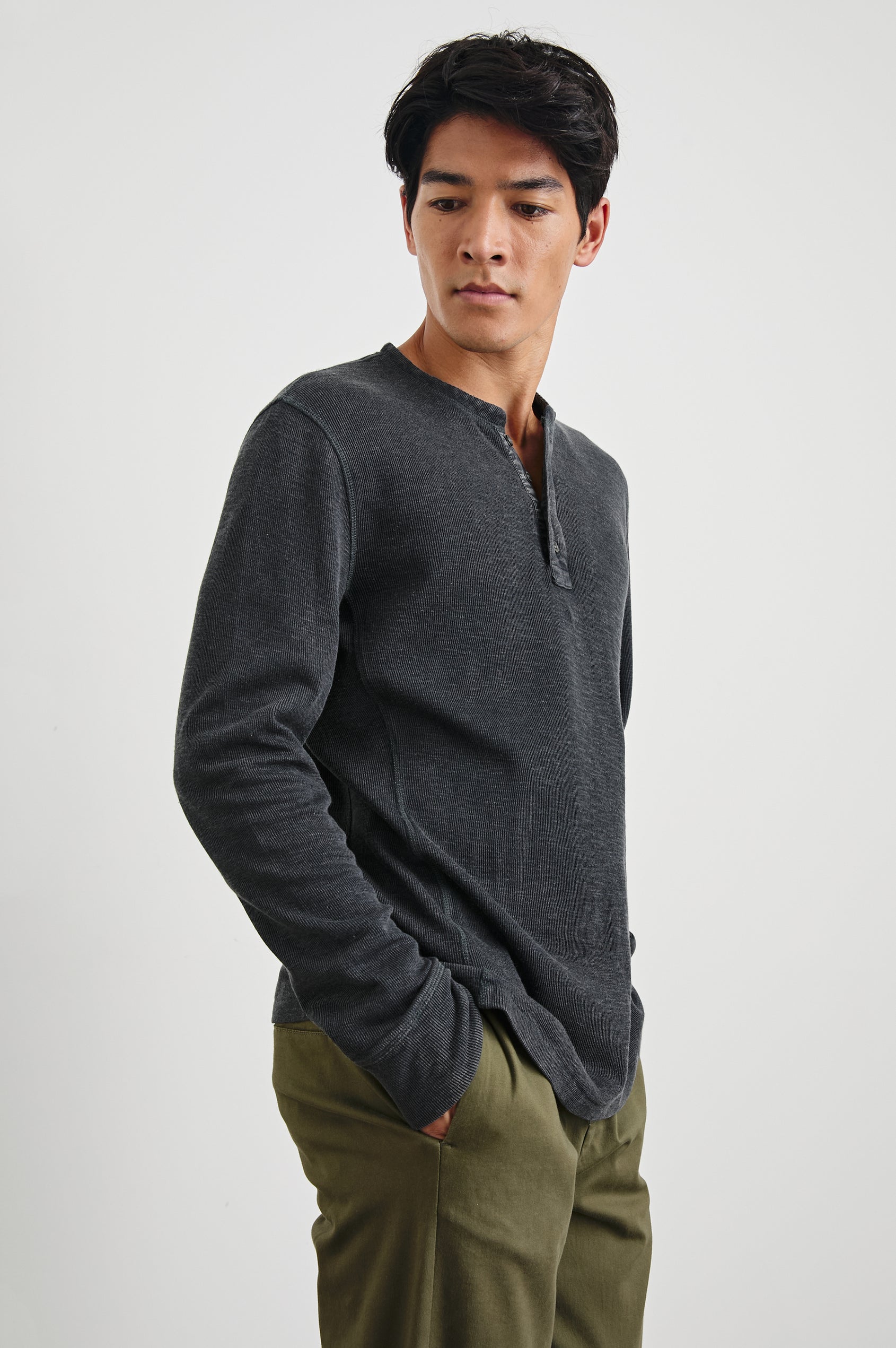 Soto Long-Sleeve Henley with a Four Button Placket and a Crew Neck in Washed Black Colorway - Side View Featured on Model