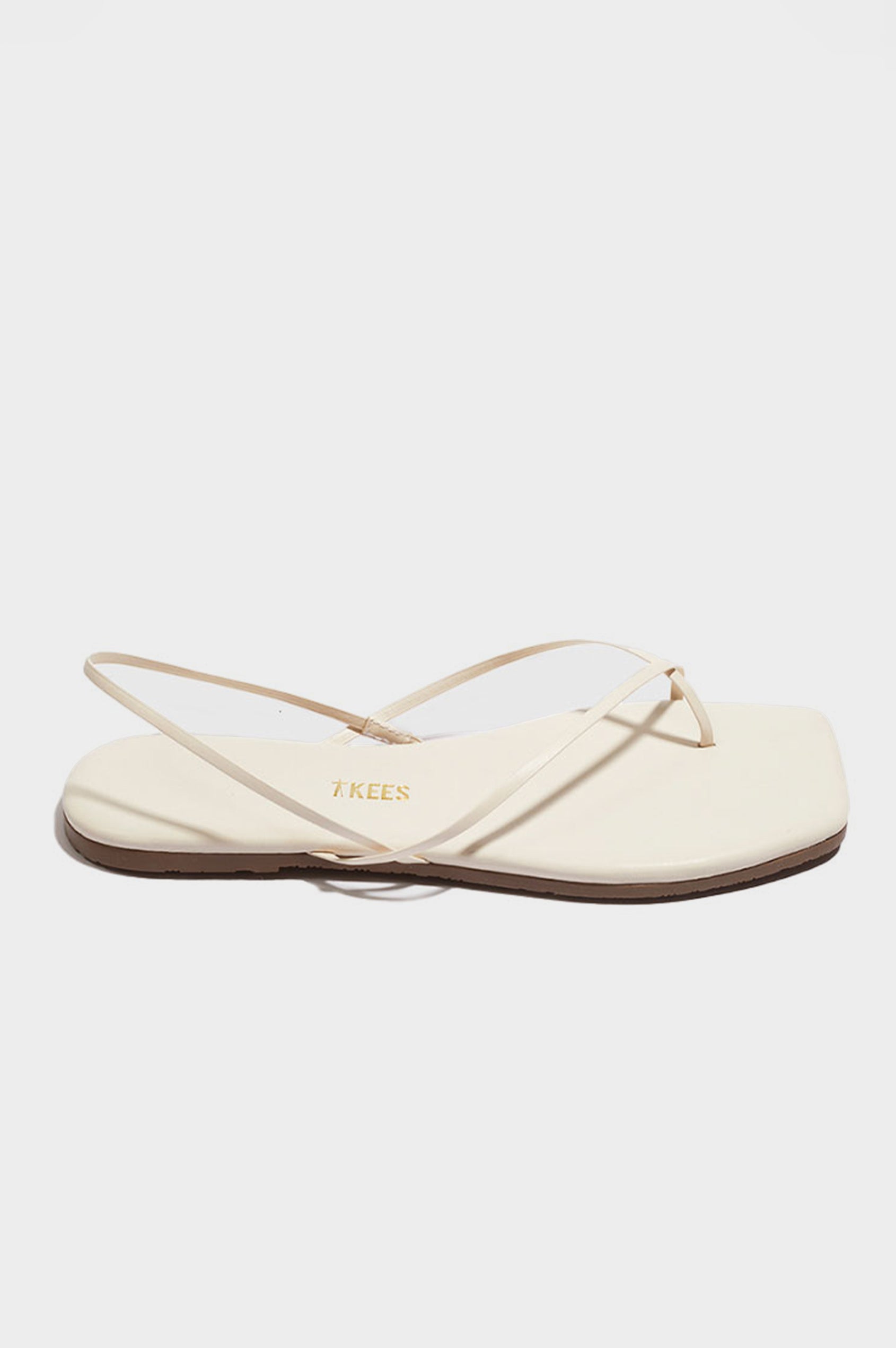 Millie Square toe leather sandal with thin straps wrapping the ankle and front in Cream white - side view of single shoe