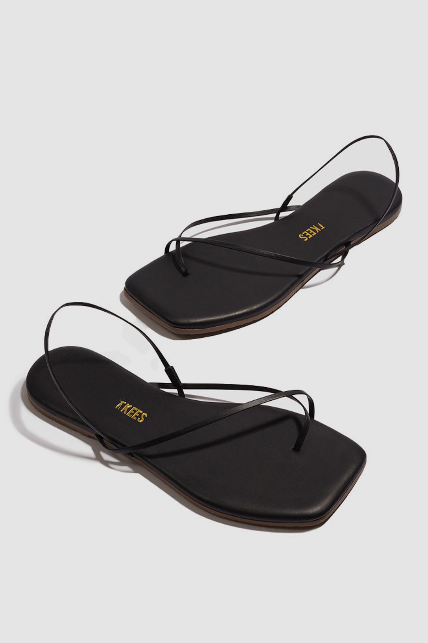 Millie Square toe leather sandal with thin straps wrapping the ankle and front in Sable black - cross angled view of pair of shoes
