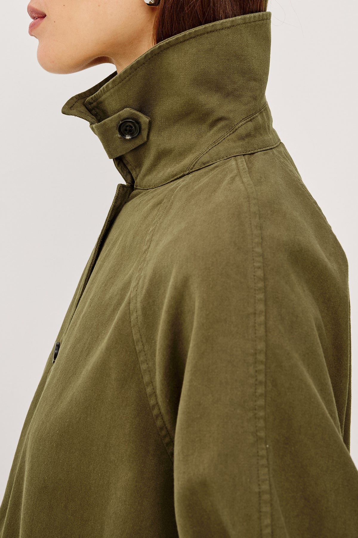 Stafford Jacket in Cotton Canvas With Relaxed Fit, Open Collar With Buttons for Funnel Neckline, Dual Patch Pockets, and Long Sleeves in Olive Colorway - Upper Body Side View Featured on Model