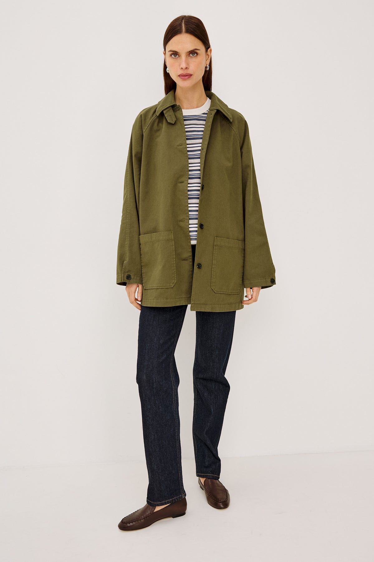 Stafford Jacket in Cotton Canvas With Relaxed Fit, Open Collar With Buttons for Funnel Neckline, Dual Patch Pockets, and Long Sleeves in Olive Colorway - Full Body Front View Featured on Model