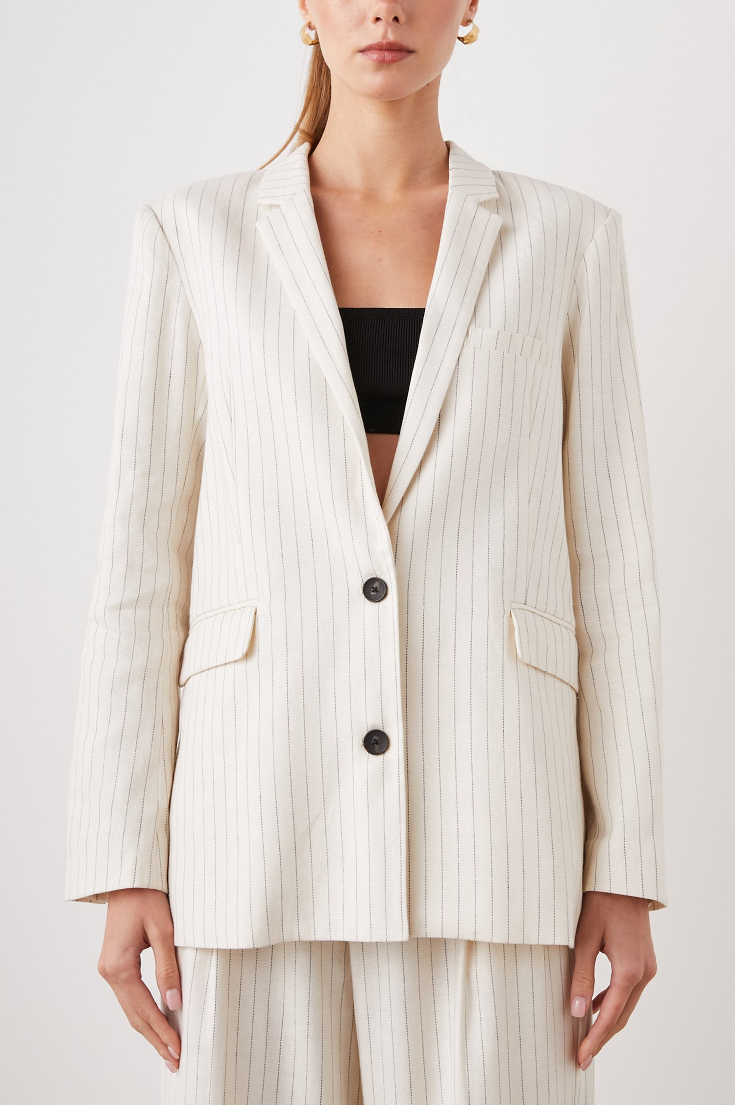 Stanton Blazer with Two Button Closure, Two Front Flap Pockets, a Chest Patch Pocket and Four-Button Cuffs in Ivory Pinstripe Colorway - Front View Featured on Model