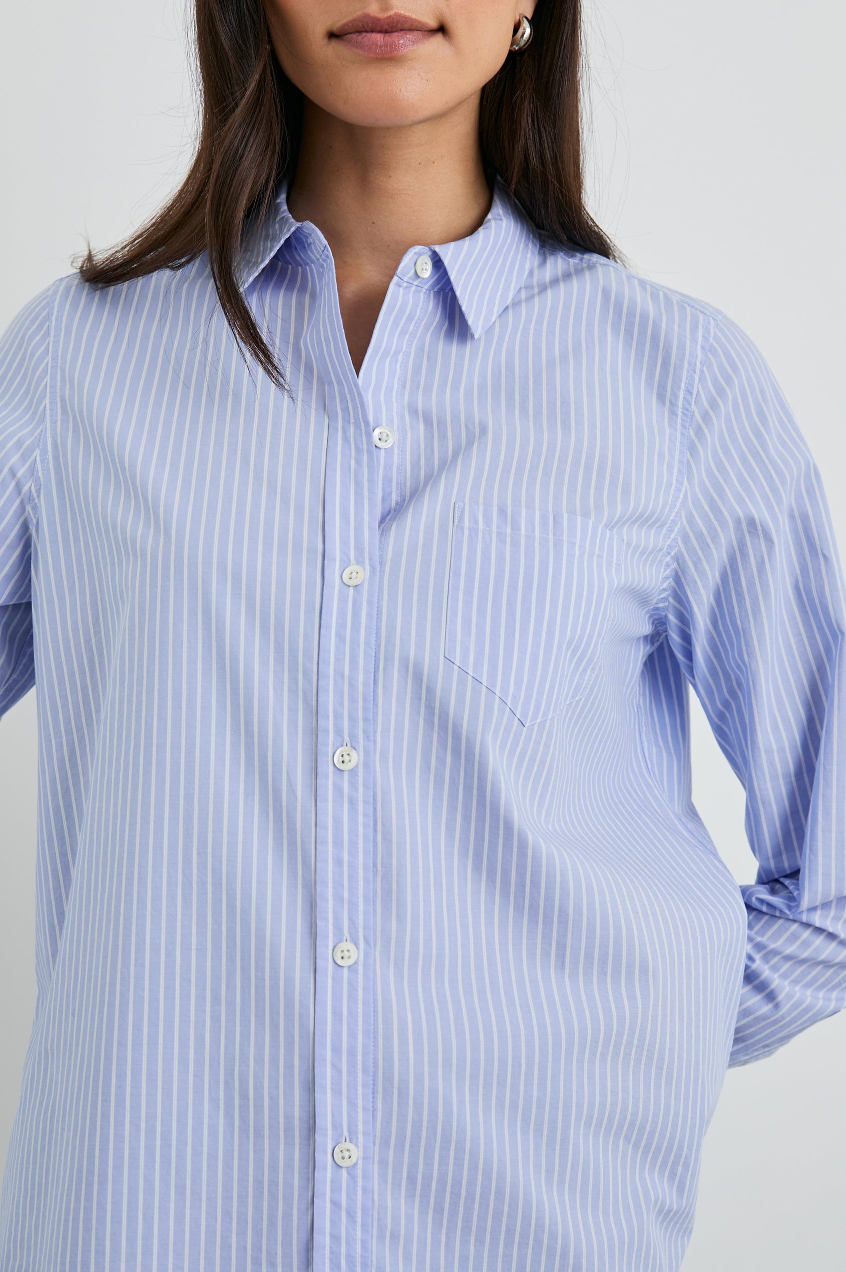 Stina Long-Sleeve Button Up with a Chest Patch Pocket in Oxford White Stripe Colorway, Thin White Vertical Stripes on Blue - Front View Featured on Model