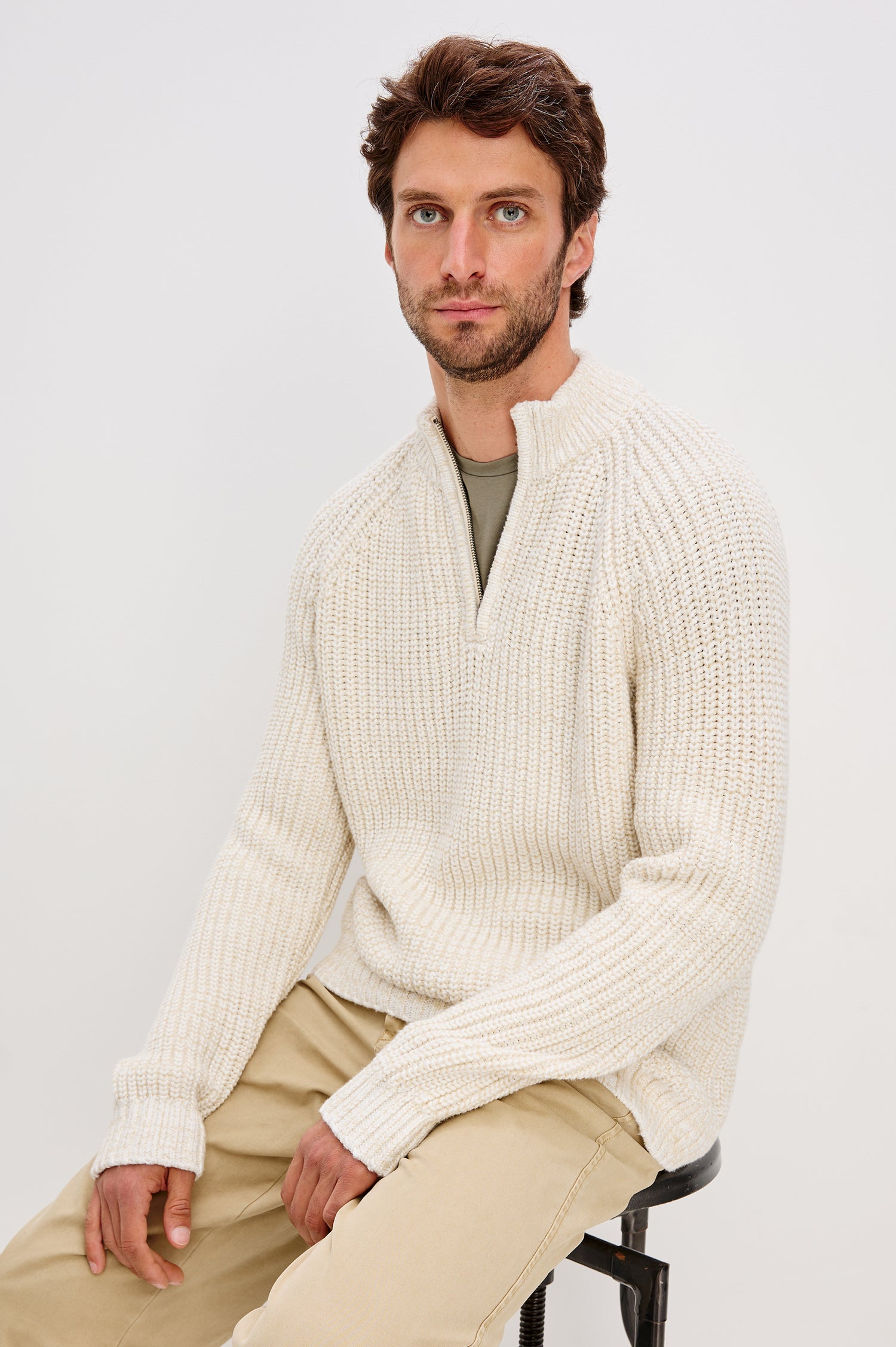 Stratton Quarter Zip Sweater in Chunky Cotton Blend Knit With Stand Collar, Long Sleeves, and Ribbed Trim in Snowdrift Marl Colorway - Upper Body Front View Featured on Model Sitting