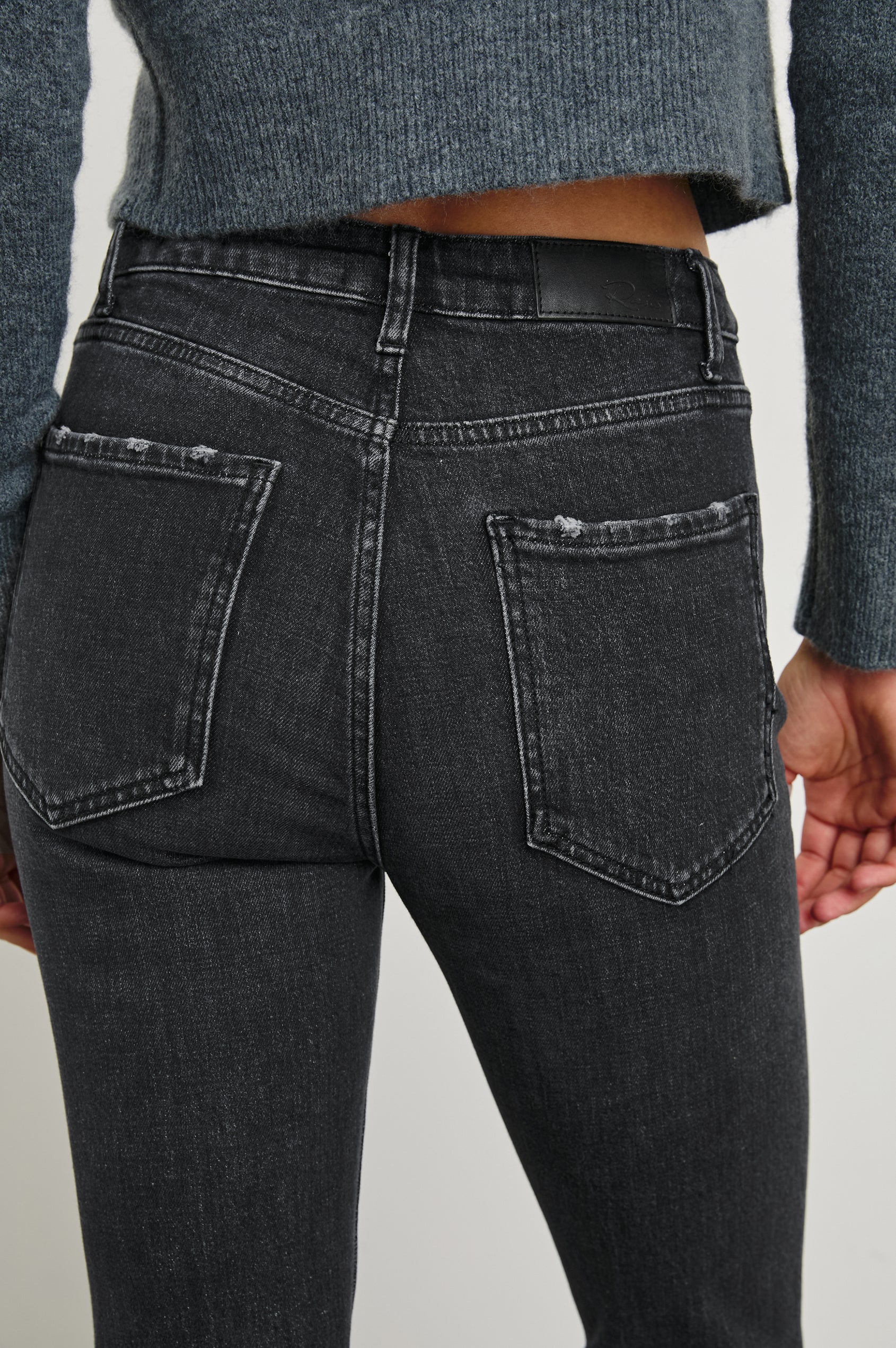 Sunset Crop Slim Fare Jeans with Belt Loops, Two Front Pockets plus a Coin Pocket and Two Back Patch Pockets in Black Pearl Colorway - Back View Featured on Model