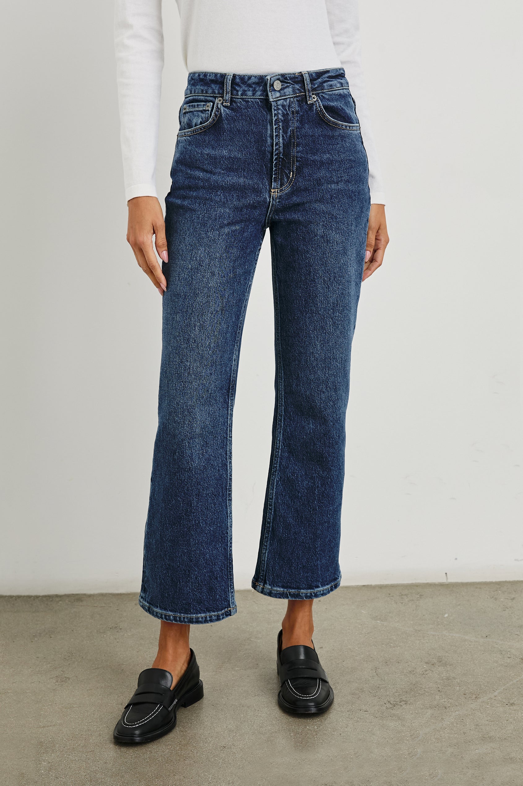 Sunset Crop Slim Fare Jeans with Belt Loops, Two Front Pockets plus a Coin Pocket and Two Back Patch Pockets in Collegiate Blue Colorway - Front View Featured on Model