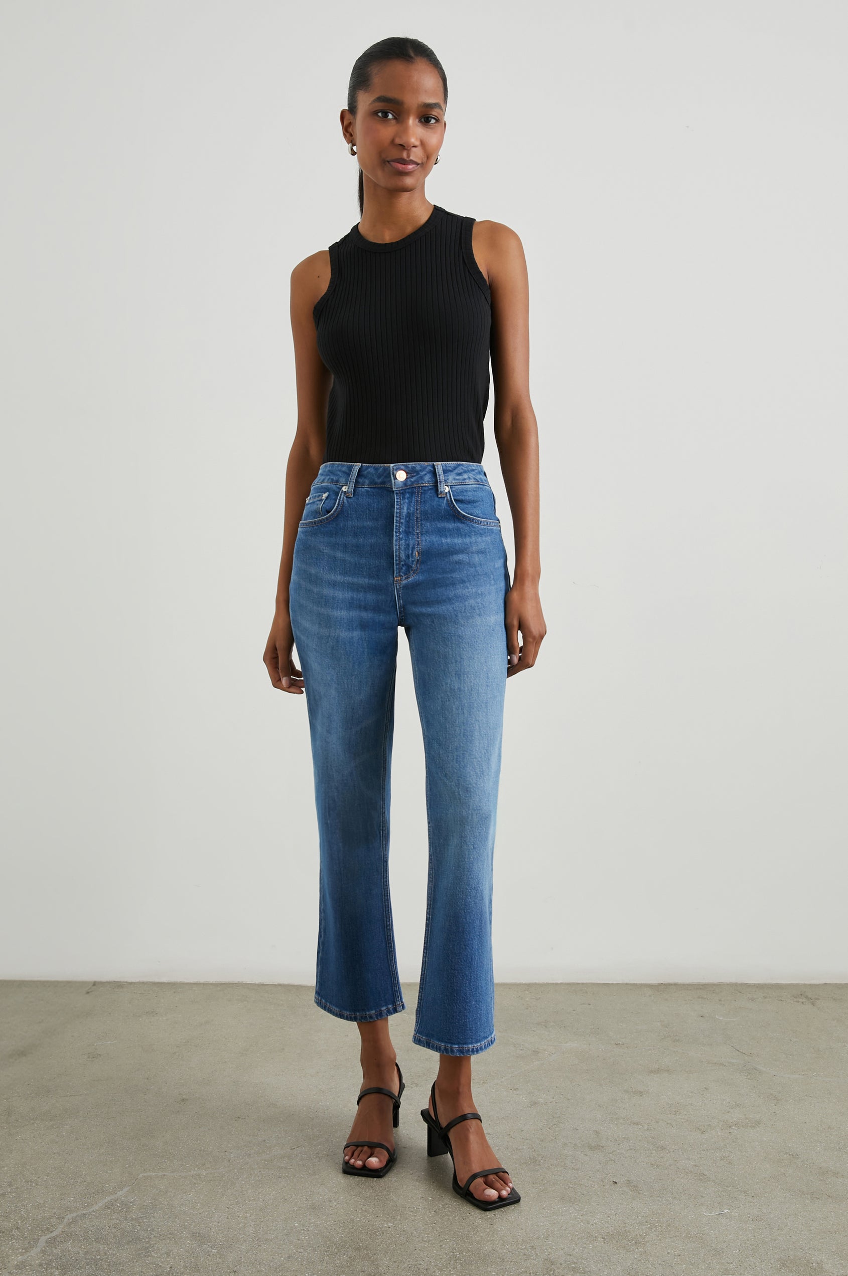 Sunset Crop Slim Fare Jeans with Belt Loops, Two Front Pockets plus a Coin Pocket and Two Back Patch Pockets in Tidal Wave Colorway - Front Full Body View Featured on Model