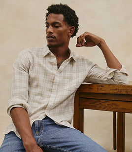 Male model wearing plaid button down shirt and jeans