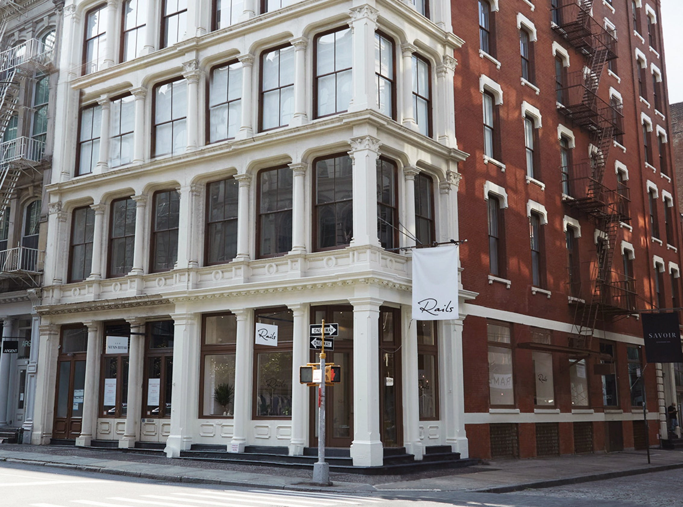 OUTSIDE OF THE RAILS STORE IN SOHO SHOWING THE ENTIRE BUILDING AND SOME OF THE NEW YORK CITY SIDE WALK