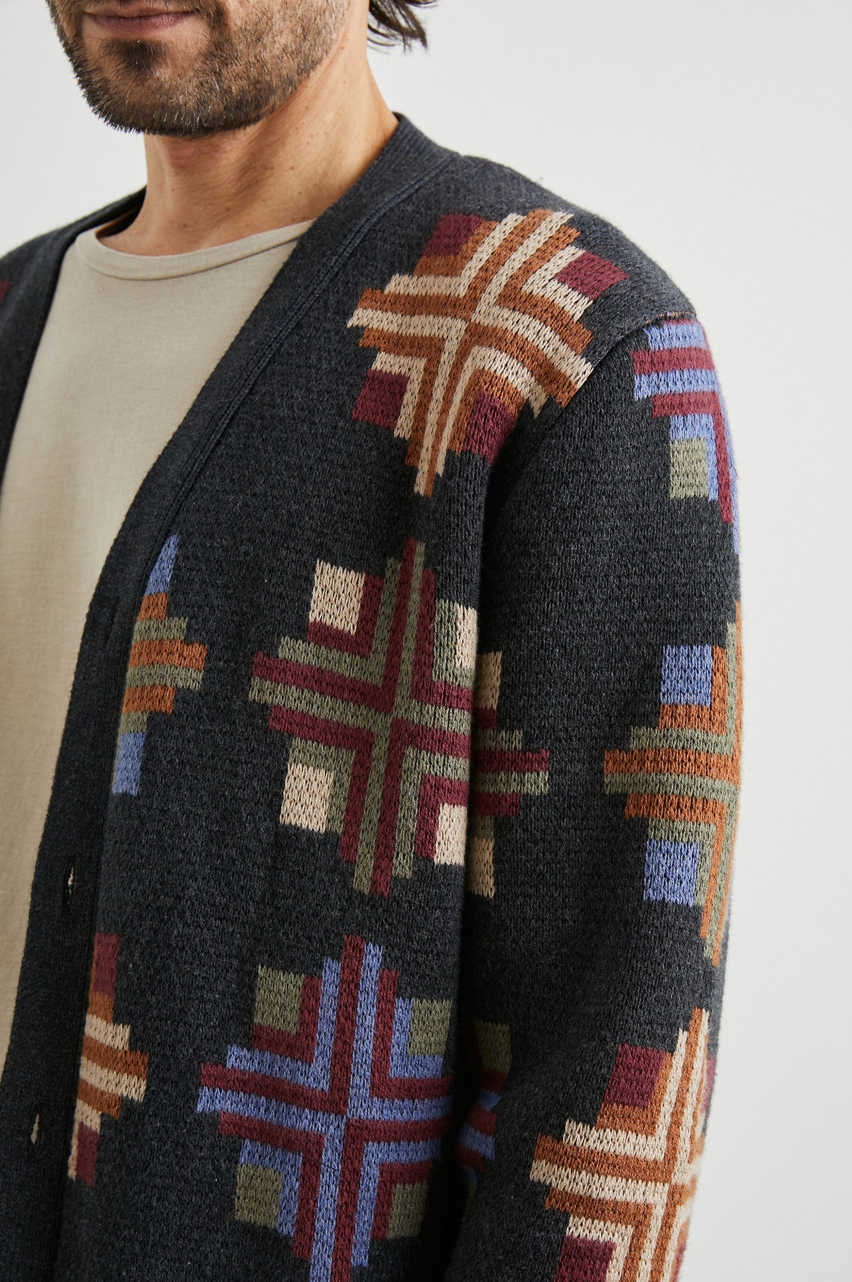 Taos Long-Sleeve Cardigan with Button Closure, V Neck and Ribbed Trim in Heirloom Patchwork Colorway, Multi-Colored Geometric Designs on Dark Grey - Front View Featured on Model