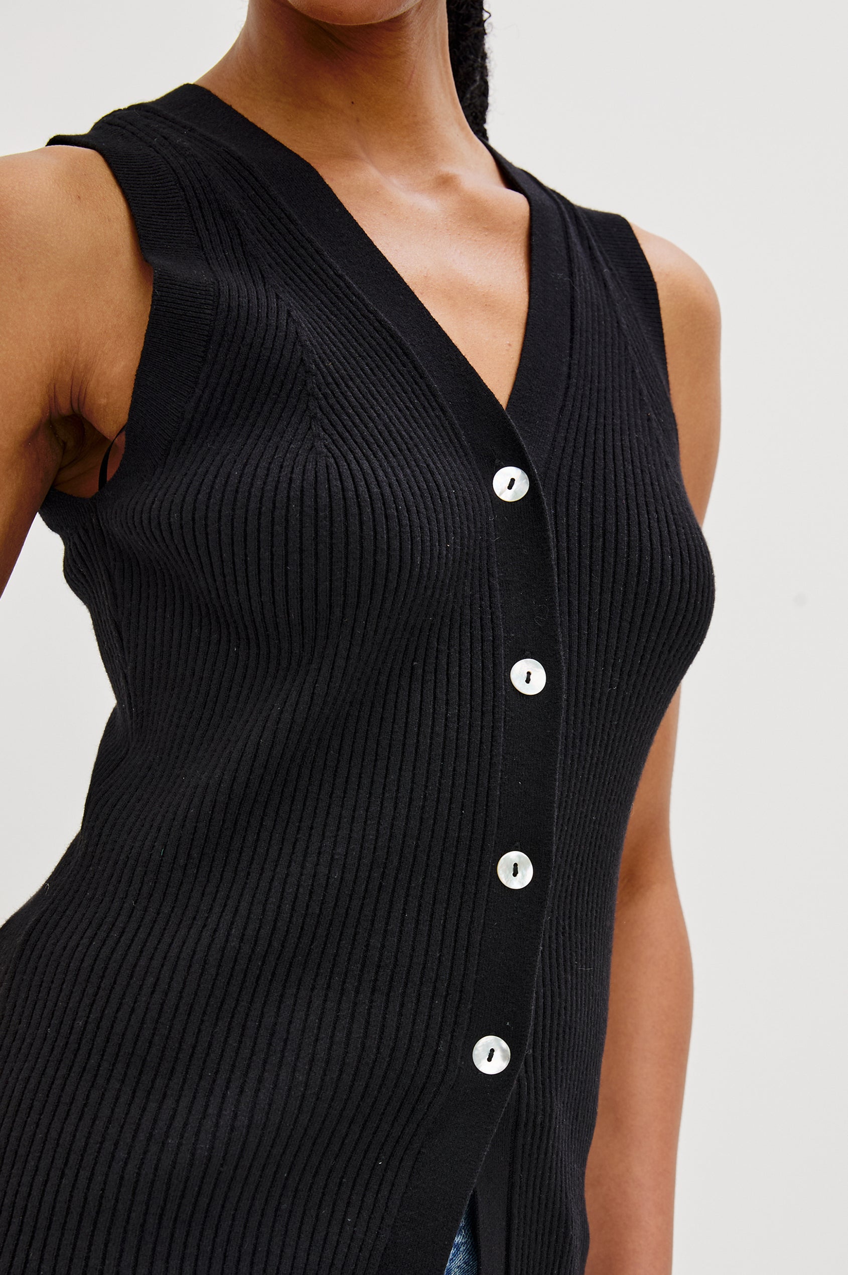 Tatia V-Neck Button Front Vest in Black Colorway. Front Detailed View Shown on Model.