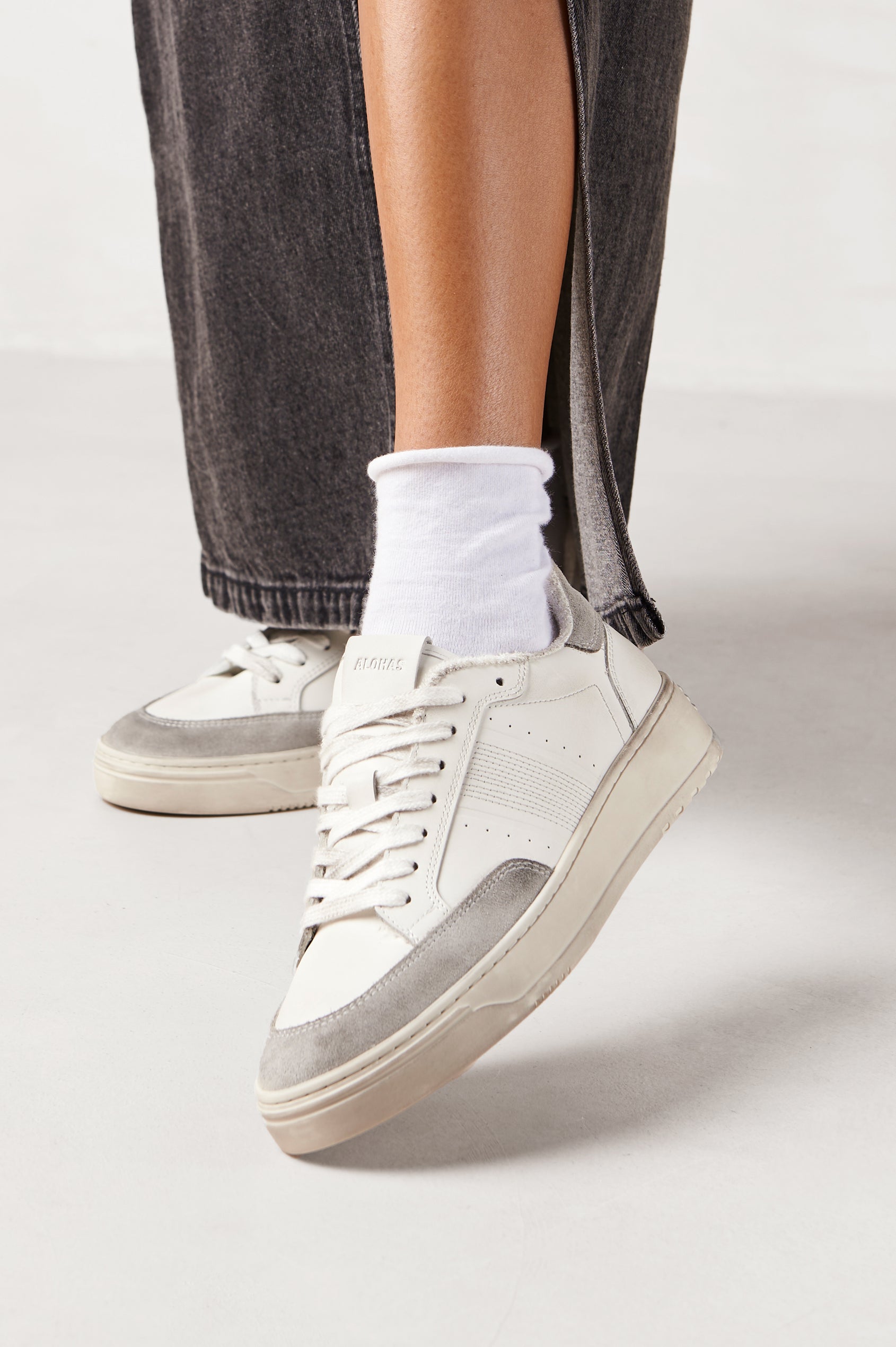 TB.780 low top, lace up sneaker with thick rubber soles, suede panels, and distressing details in Dusty Light Grey - side view of shoe on model