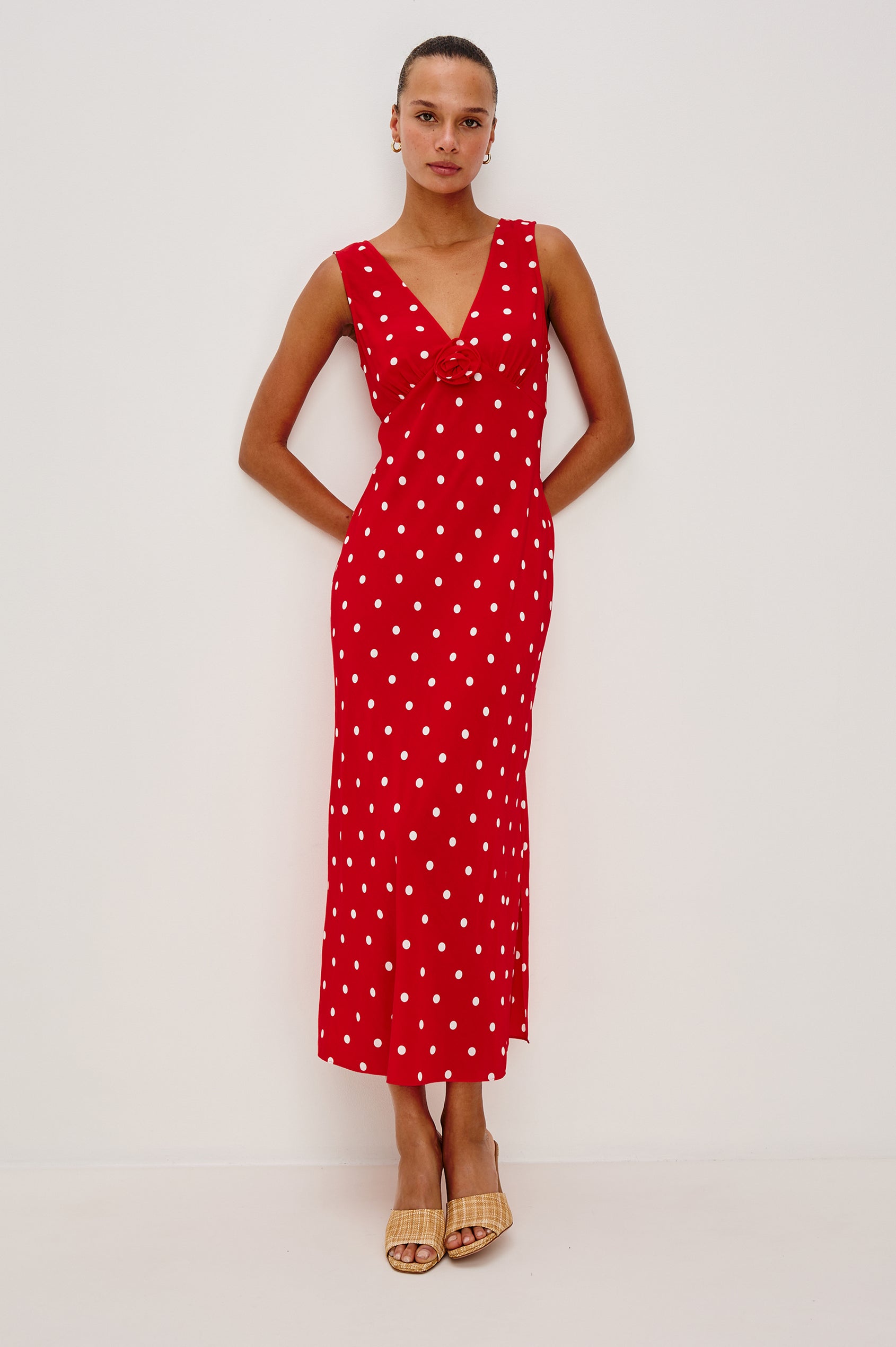Terena midi dress in Rossa colorway featuring a V neckline, polka dot pattern and fabricated rose at the front chest - Full body front view on model