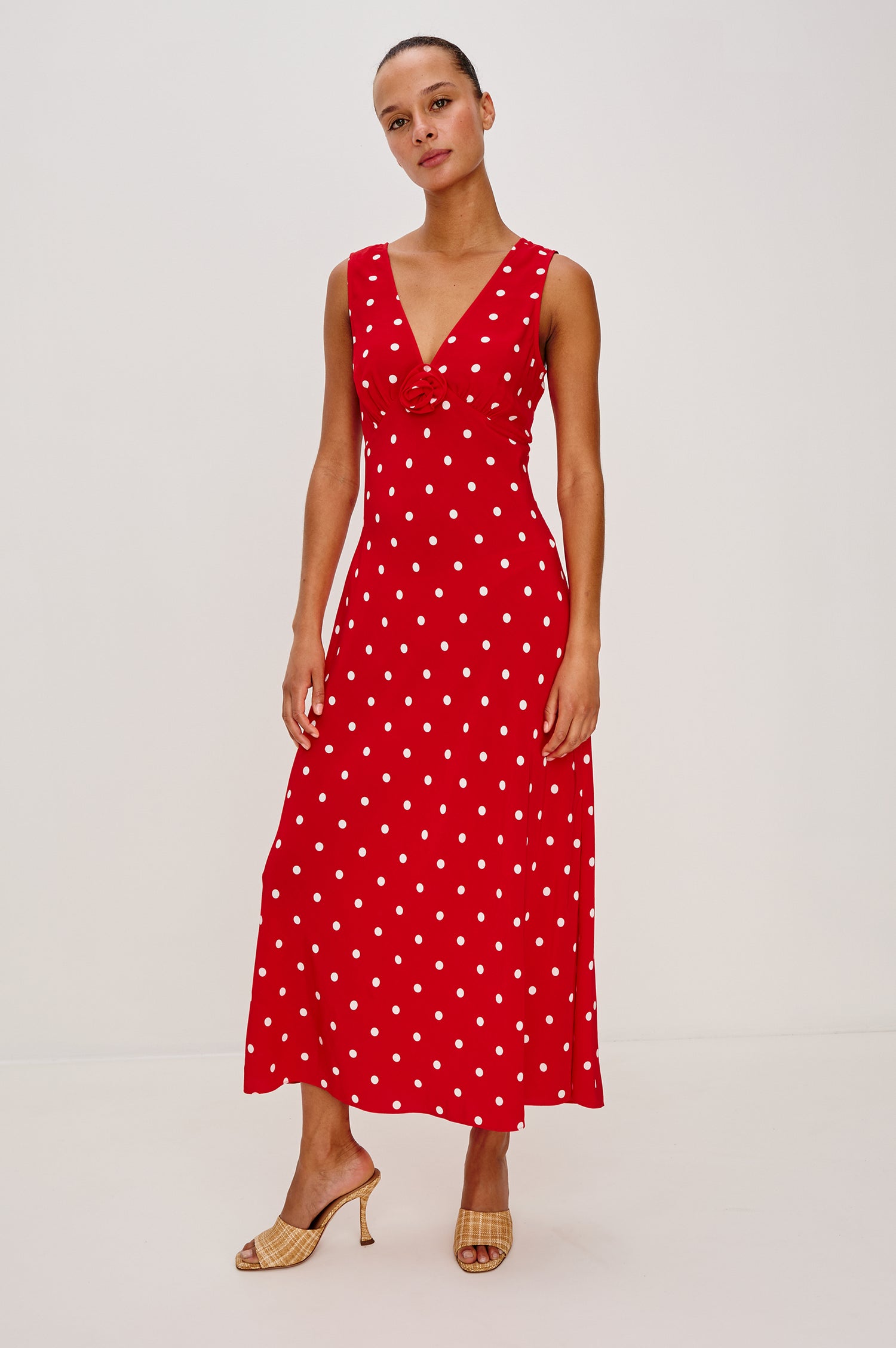 Terena midi dress in Rossa colorway featuring a V neckline, polka dot pattern and fabricated rose at the front chest - front view on model