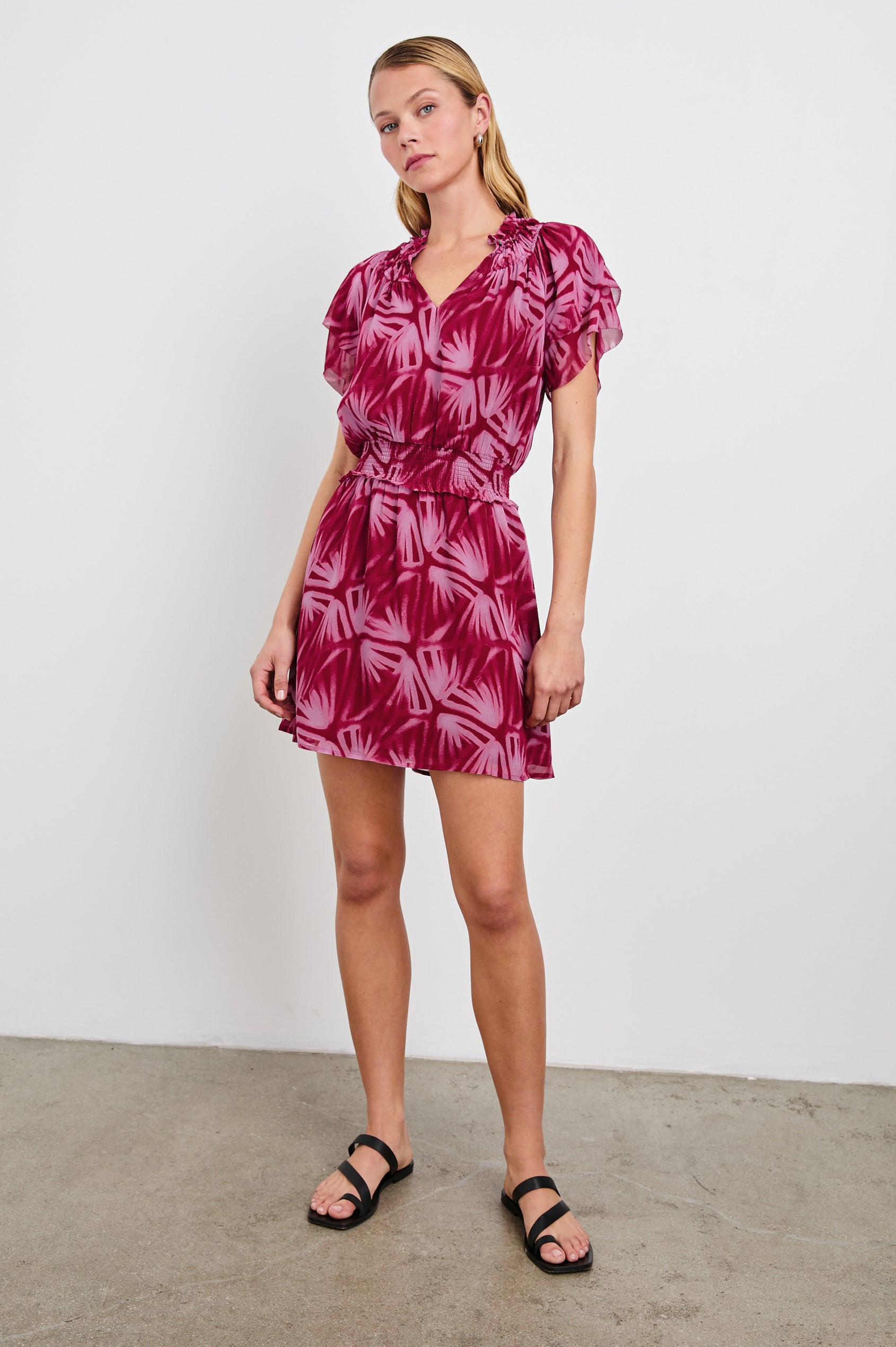 Terrin Mid-Thigh Dress with Ruffled Sleeves, a V Neck, and Shirred Collar and Waist in Bahia Colorway, a pattern in pinks - Front Full Body View Featured on model
