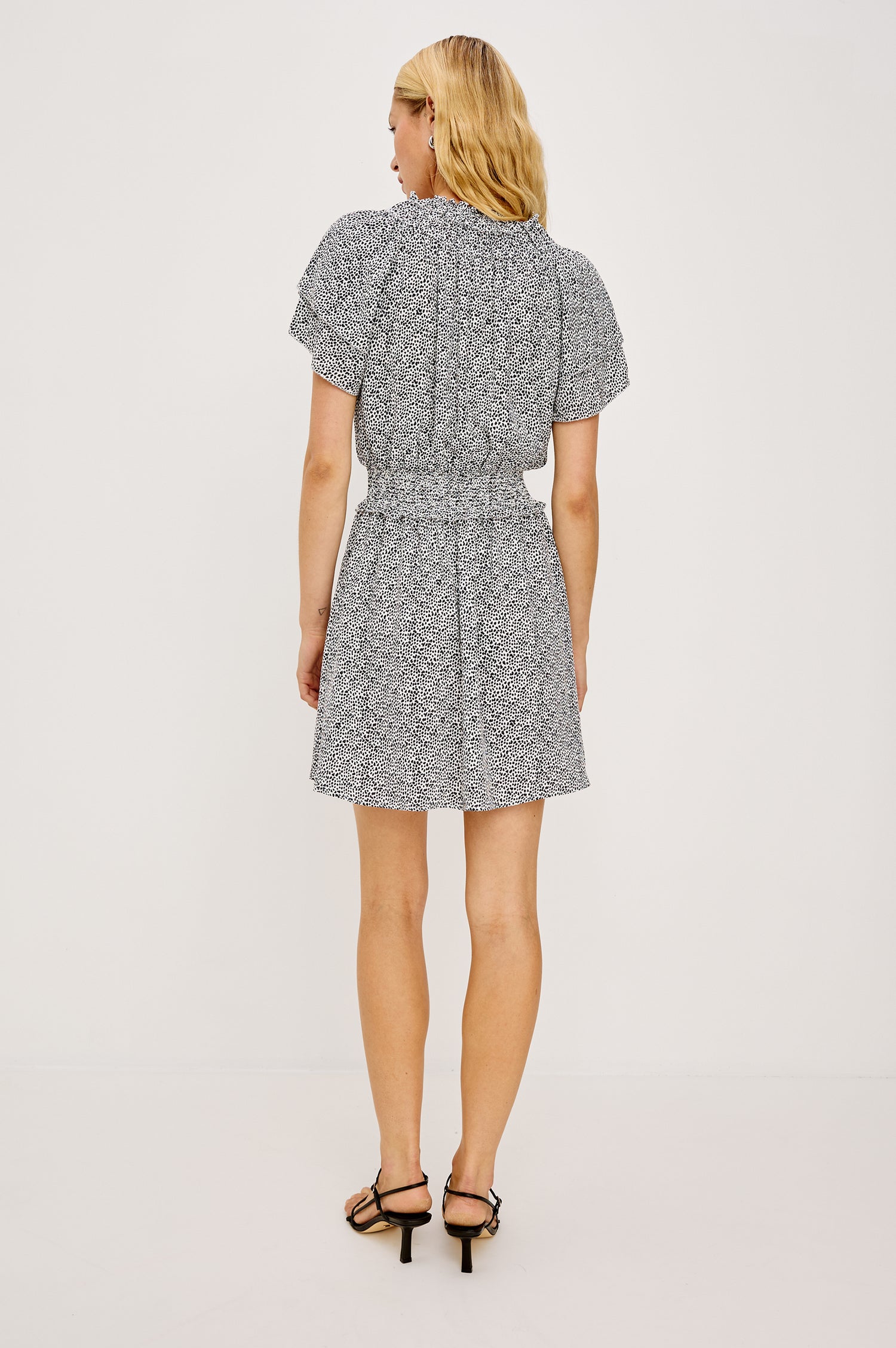 Terrin Mini Dress With Shirred Yoke V-Neckline Tiered Short Sleeves Smocked Waist and Fully Lined Skirt in Ivory Micro Spots Colorway - Full Body Back View Featured on Model