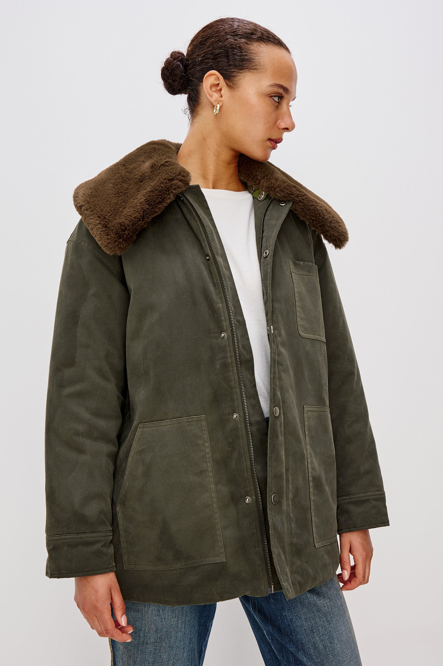 Tessuto Jacket in Waxed Cotton Canvas With Removable Vegan Fur Collar, Front Zip With Snap Closures, Long Sleeves, Quilted Lining, Single Chest Patch Pocket, and Side Pockets in Umber Colorway - Upper Body Front View Featured on Model