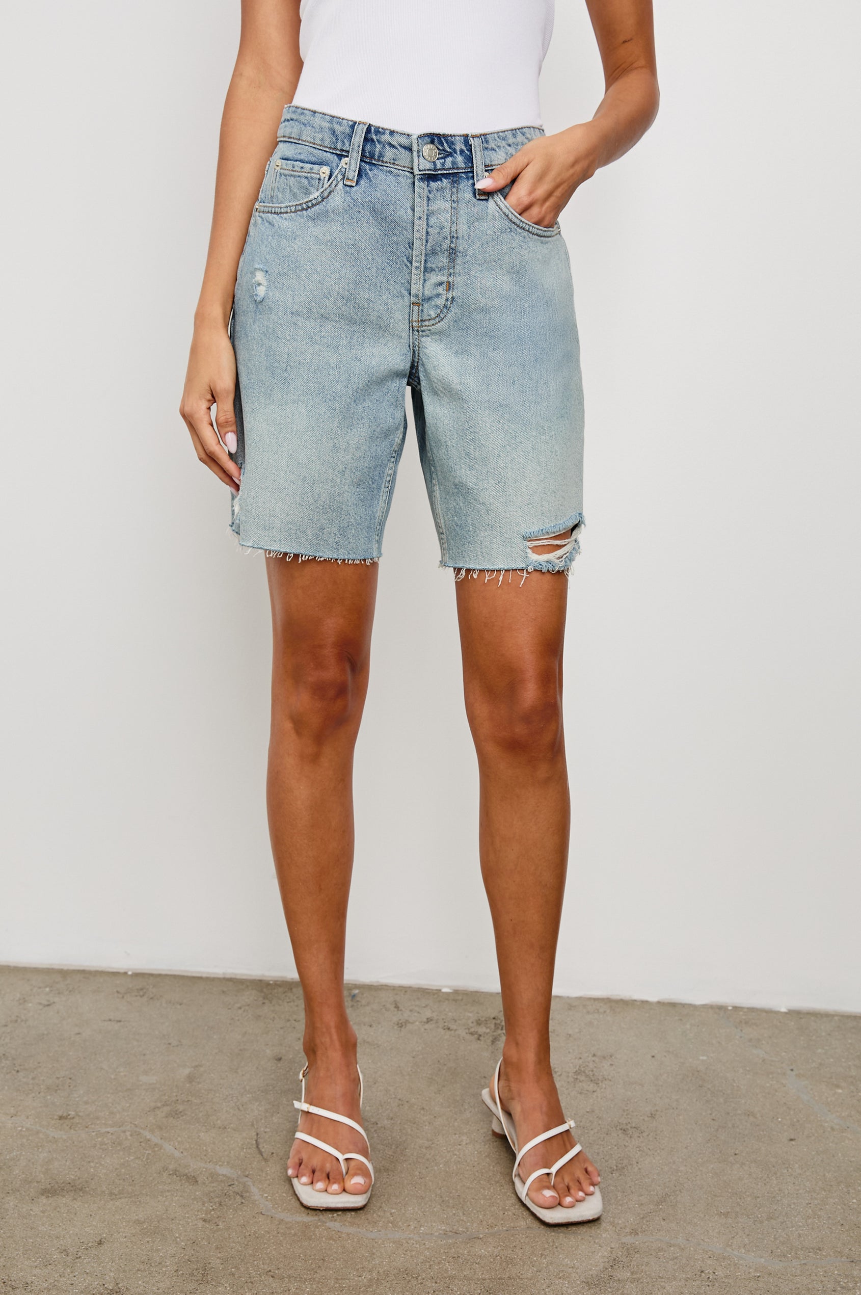 Beachwood high rise bermuda length denim short with distressing details in light wash Light Vintage Distress - front view on model, hand in pocket