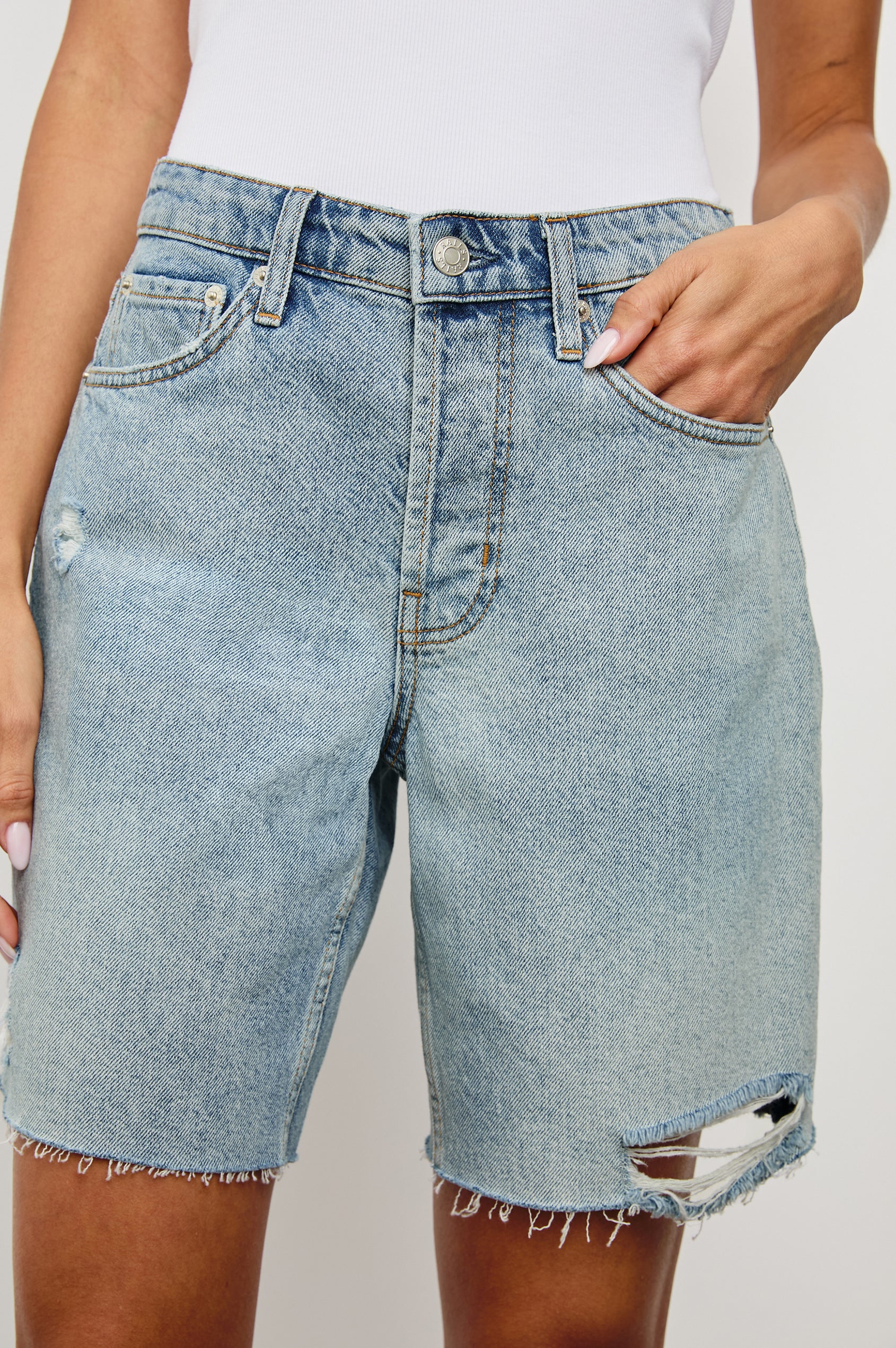 Beachwood high rise bermuda length denim short with distressing details in light wash Light Vintage Distress - close up of details on model