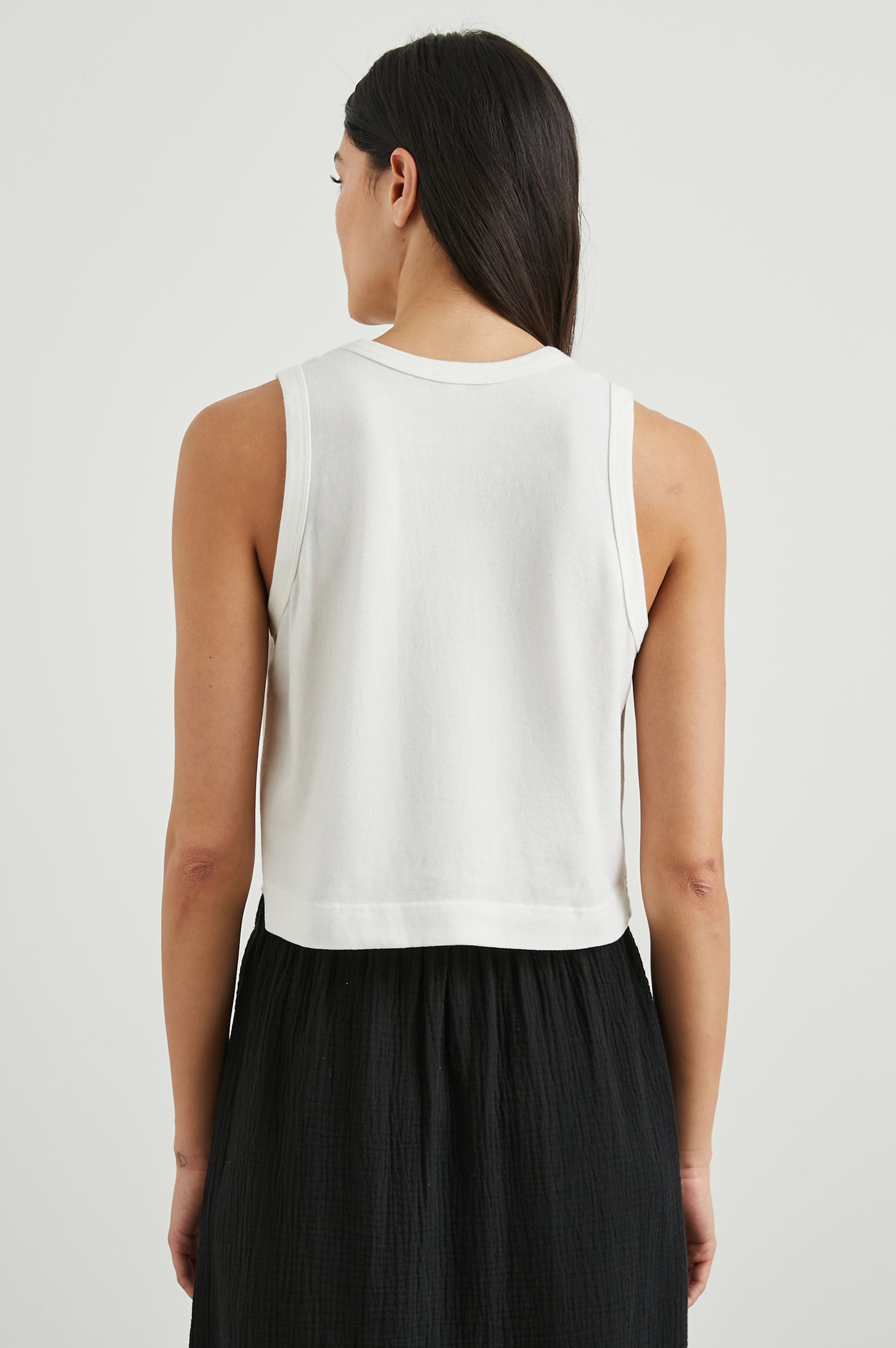 The Boxy Cropped Tank with a Crew Neck in White Colorway - Back View Featured on Model