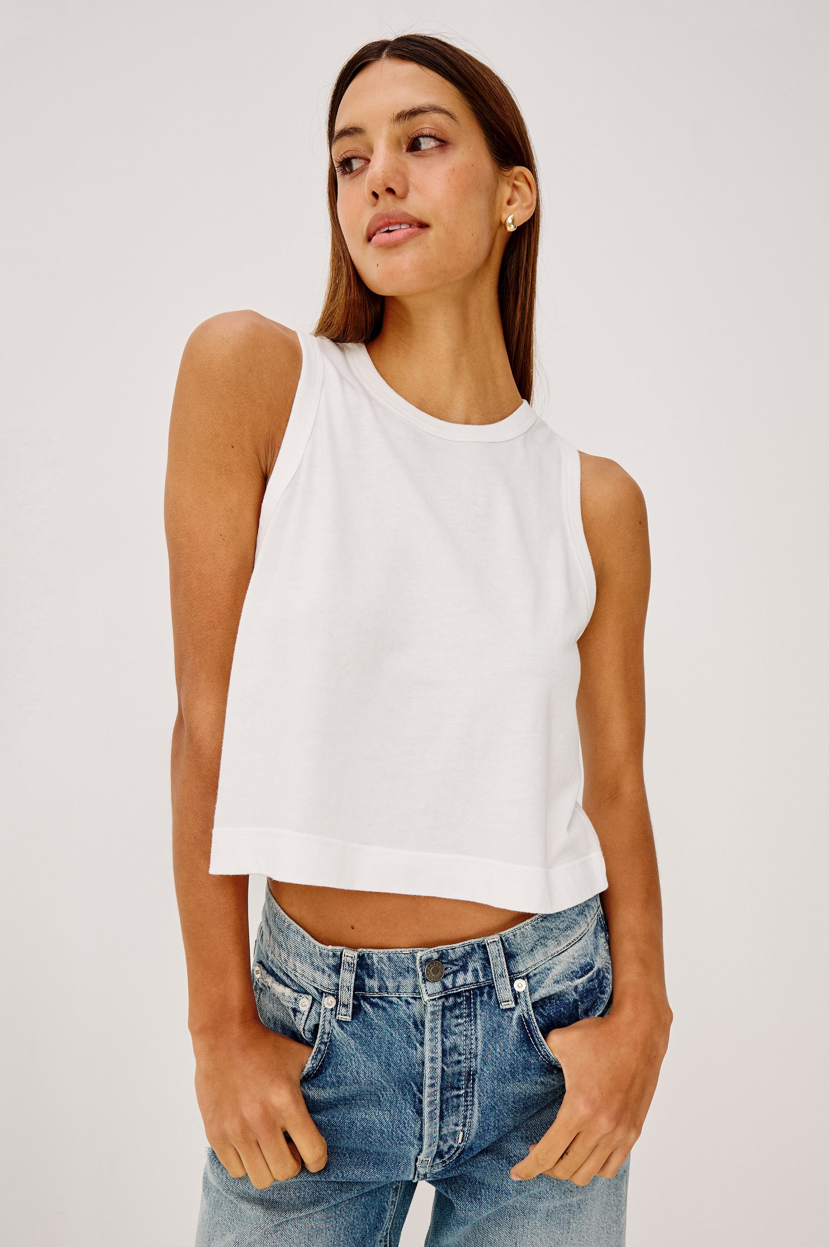 The Boxy Tank in 100% Cotton With Crew Neckline, Wide Shoulder Straps, and a Cropped, Boxy Fit in White Colorway - Upper Body Front View Featured on Model
