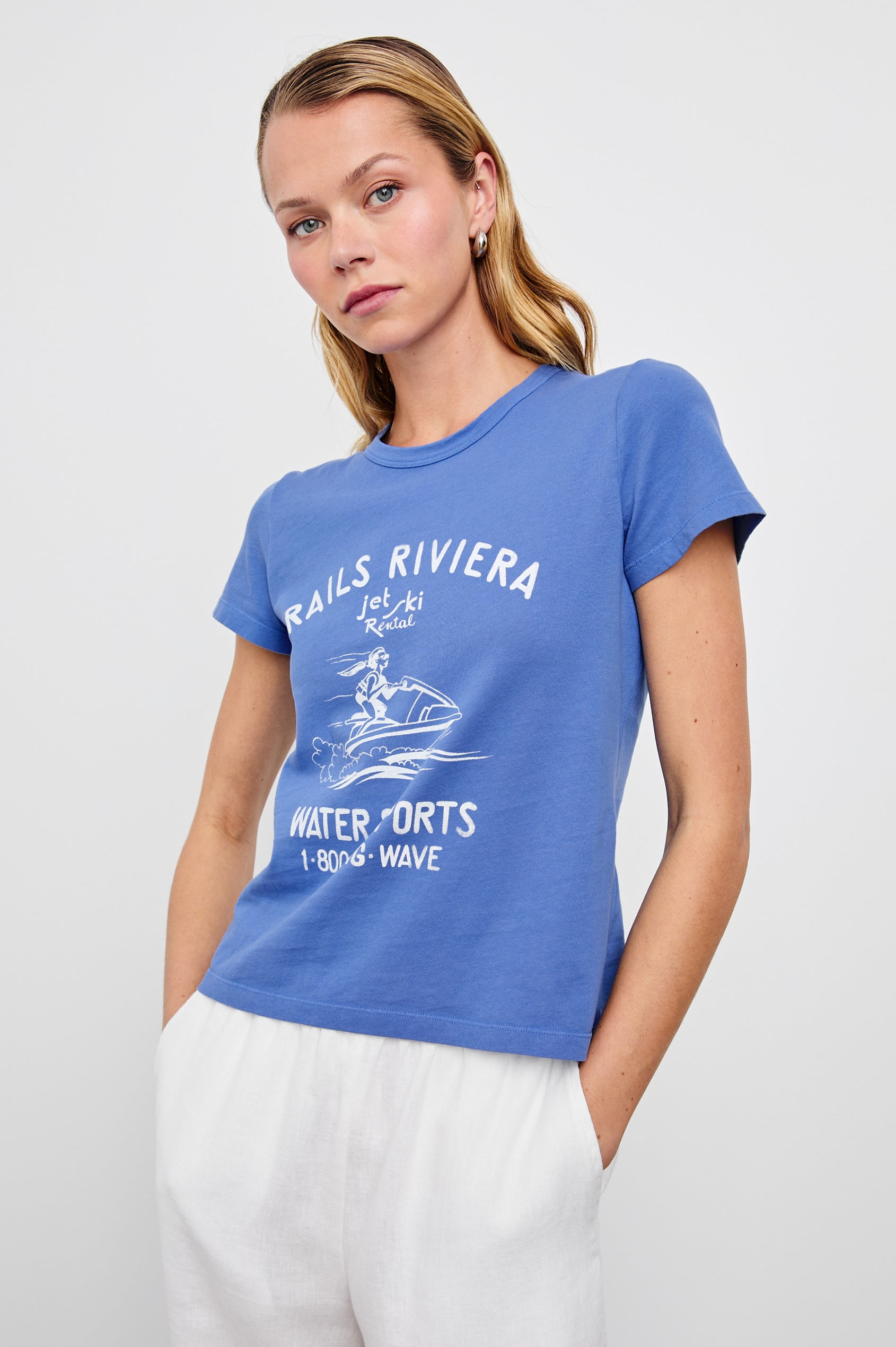 Fitted Crew T-Shirt with a jet ski image and the text Rails Riviera jet ski Rental Water Sports 1 800 Big Wave in Rails Riviera Colorway, White Text on Blue - Front View Featured on Model