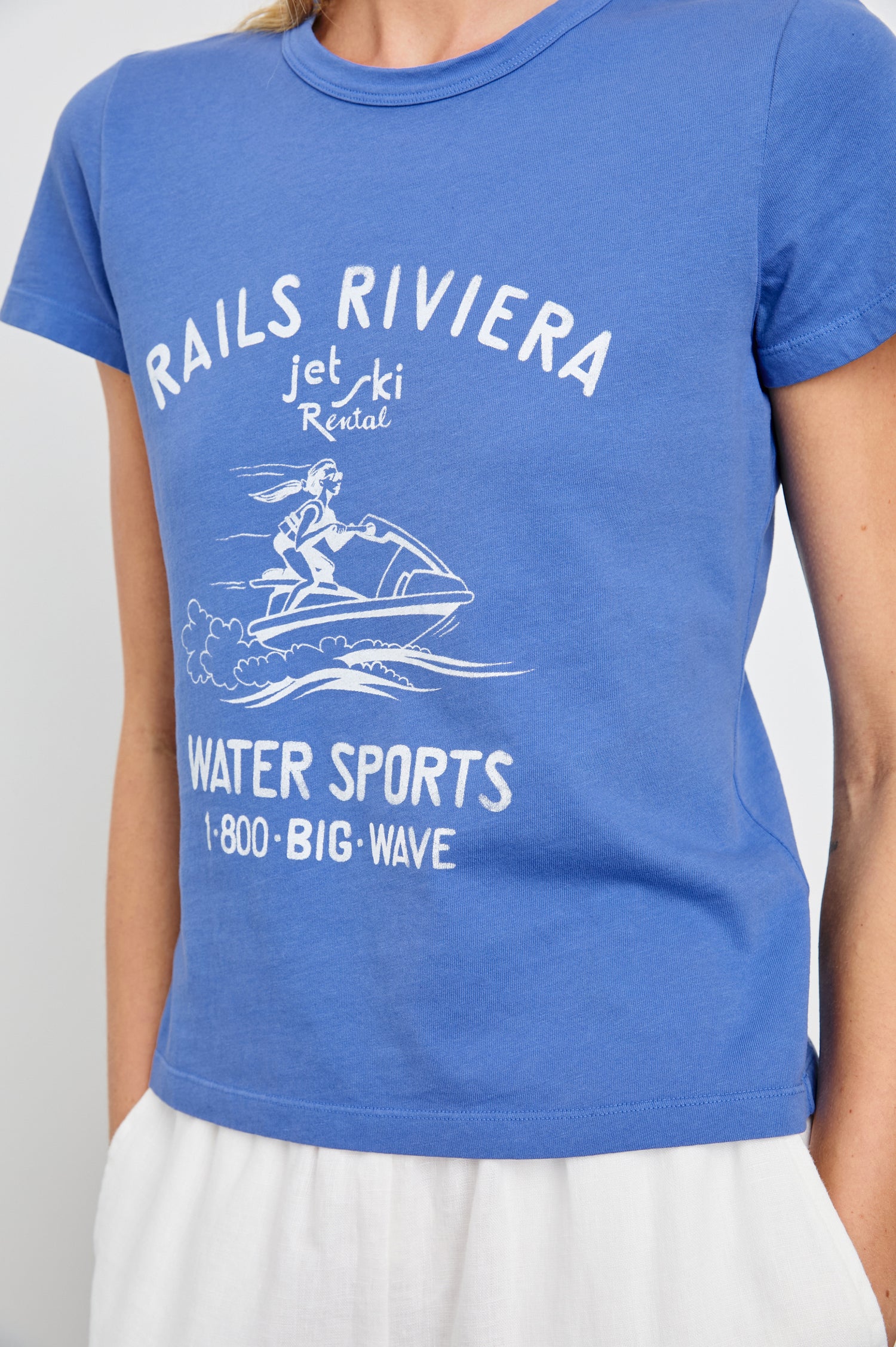 Fitted Crew T-Shirt with a jet ski image and the text Rails Riviera jet ski Rental Water Sports 1 800 Big Wave in Rails Riviera Colorway, White Text on Blue - Front View Featured on Model