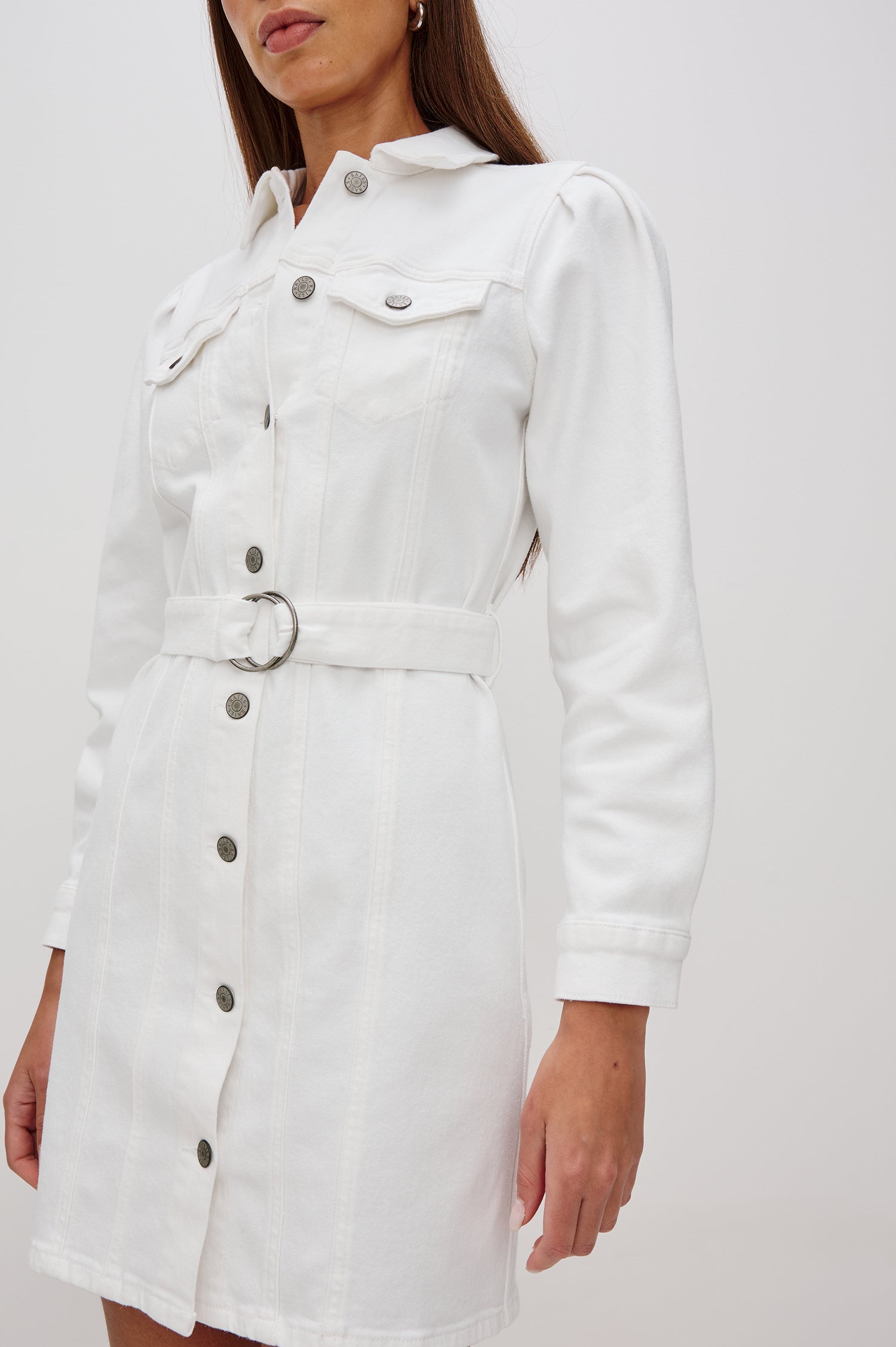 Griffith Denim Shirt Dress with Puff Shoulder Long Sleeves, Self Belt with Metal D-Rings and Chest Flap Pockets in Salt White Colorway. Front View Shown on Model.