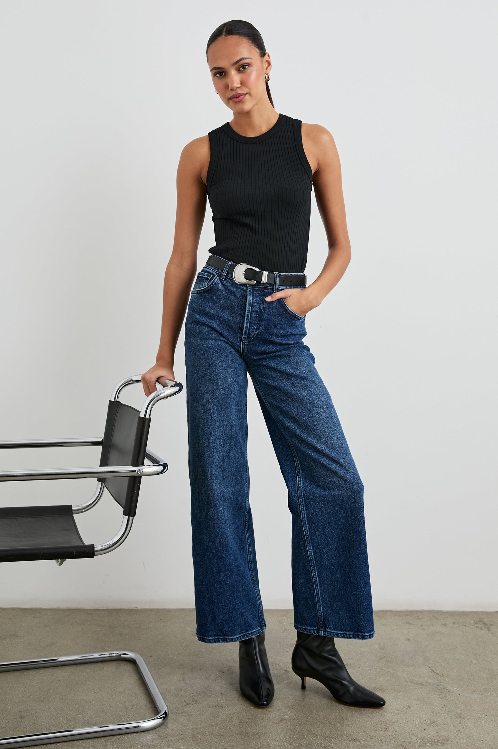 The Racer Ribbed Tank with a Crew Neckline in True Black Colorway - Front Full Body View Featured on Model