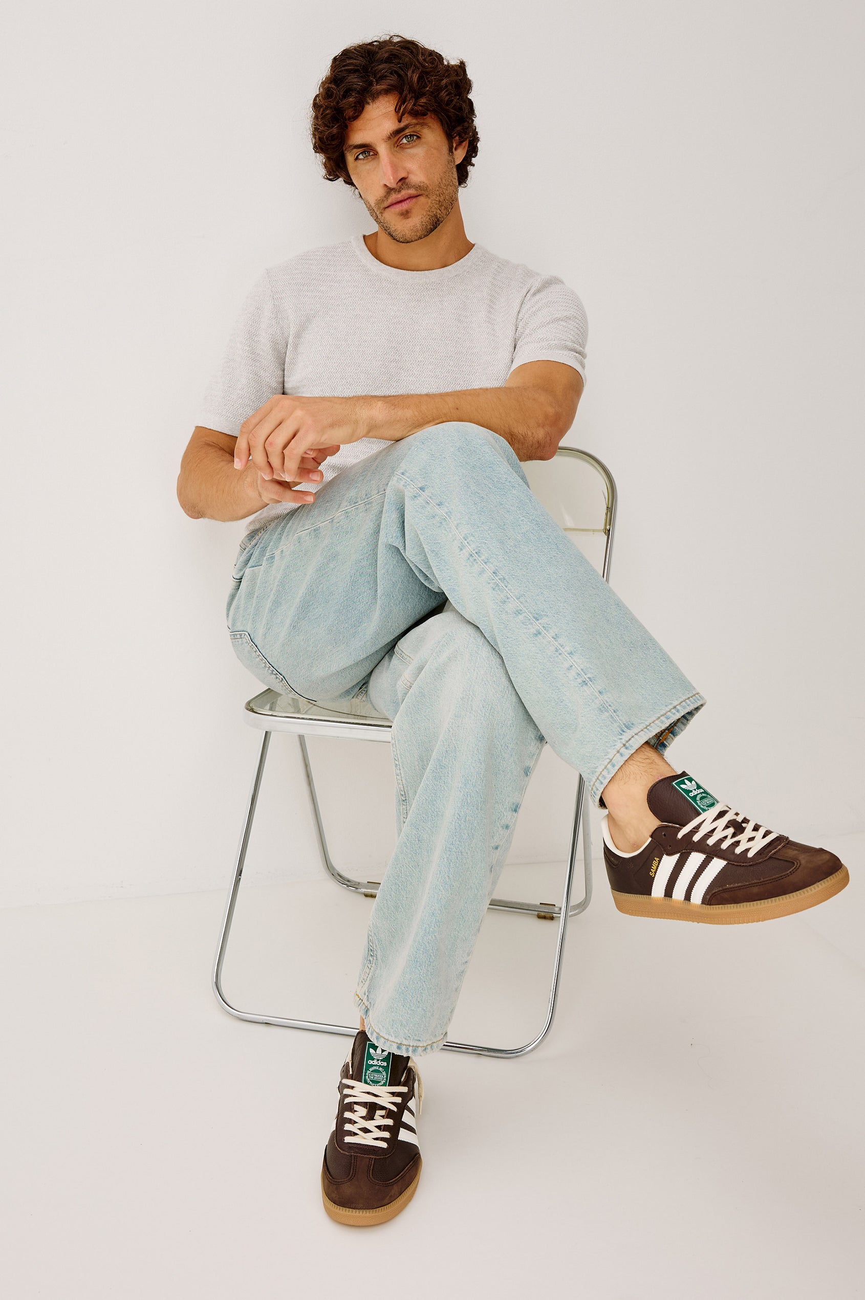 Theo Sweater in Cotton-Cashmere Blend With Short Sleeves, Crew Neckline, and Classic Fit in Heather Grey Colorway - Full Body View Featured on Model Sitting
