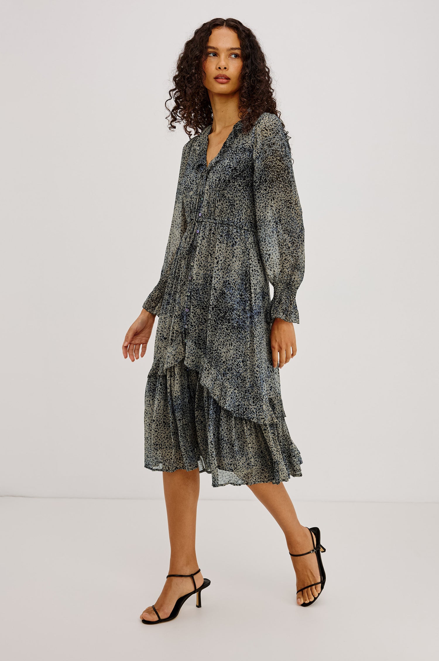 Theresa Midi Dress in Chiffon With Lined Body, Ruffle V-Neckline With Ties, Button-Loop Placket, Elastic Drawstring Waist, Long Semi-Sheer Bishop Sleeves, and Asymmetric Tier at Skirt in Agate Colorway - Full Body Front View Featured on Model