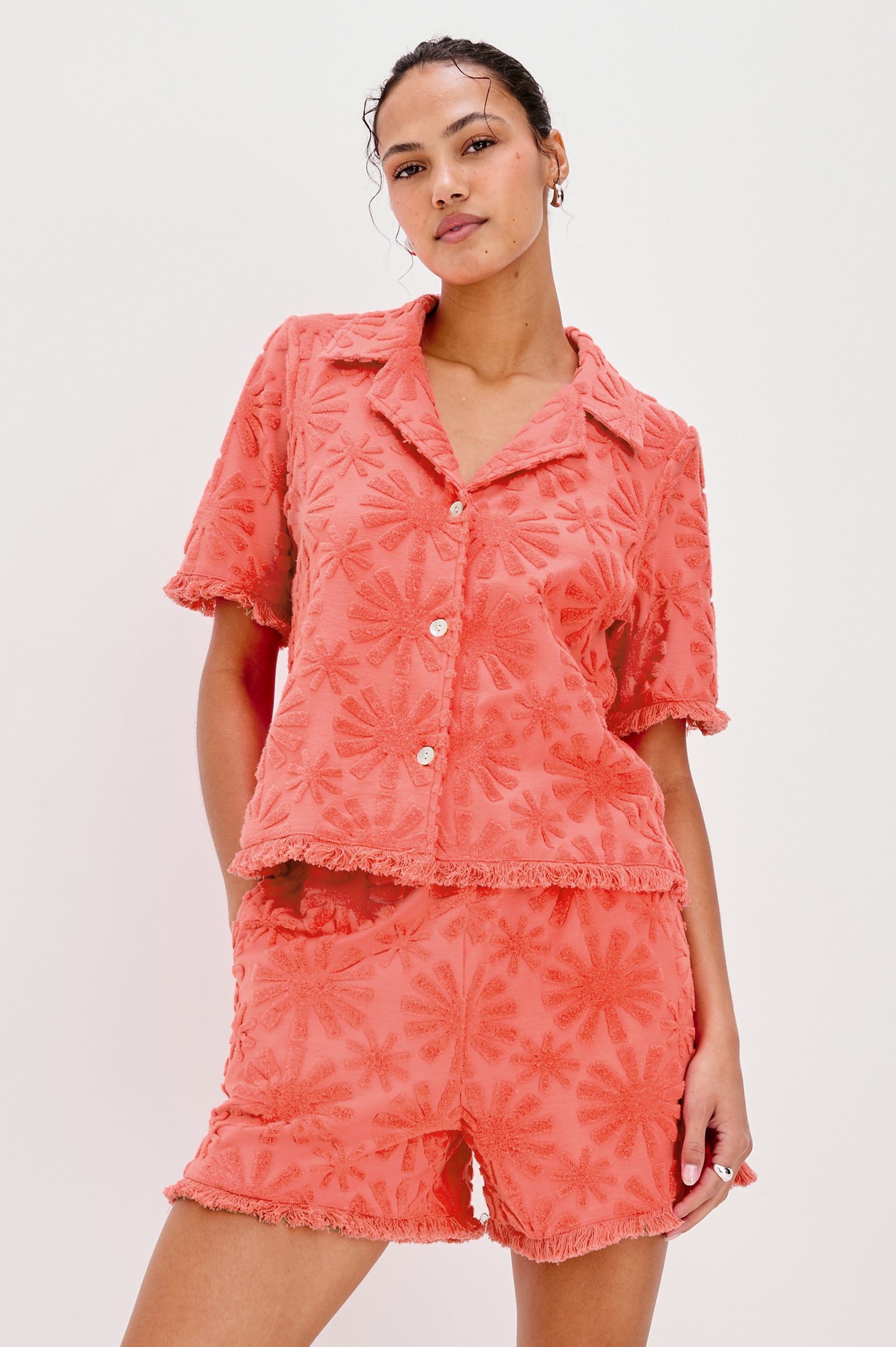 Tiff V-Neck Button Front Shirt with Short Sleeves and Fringed Hems in Red Sunburst Jacquard Colorway. Front View Shown on Model.
