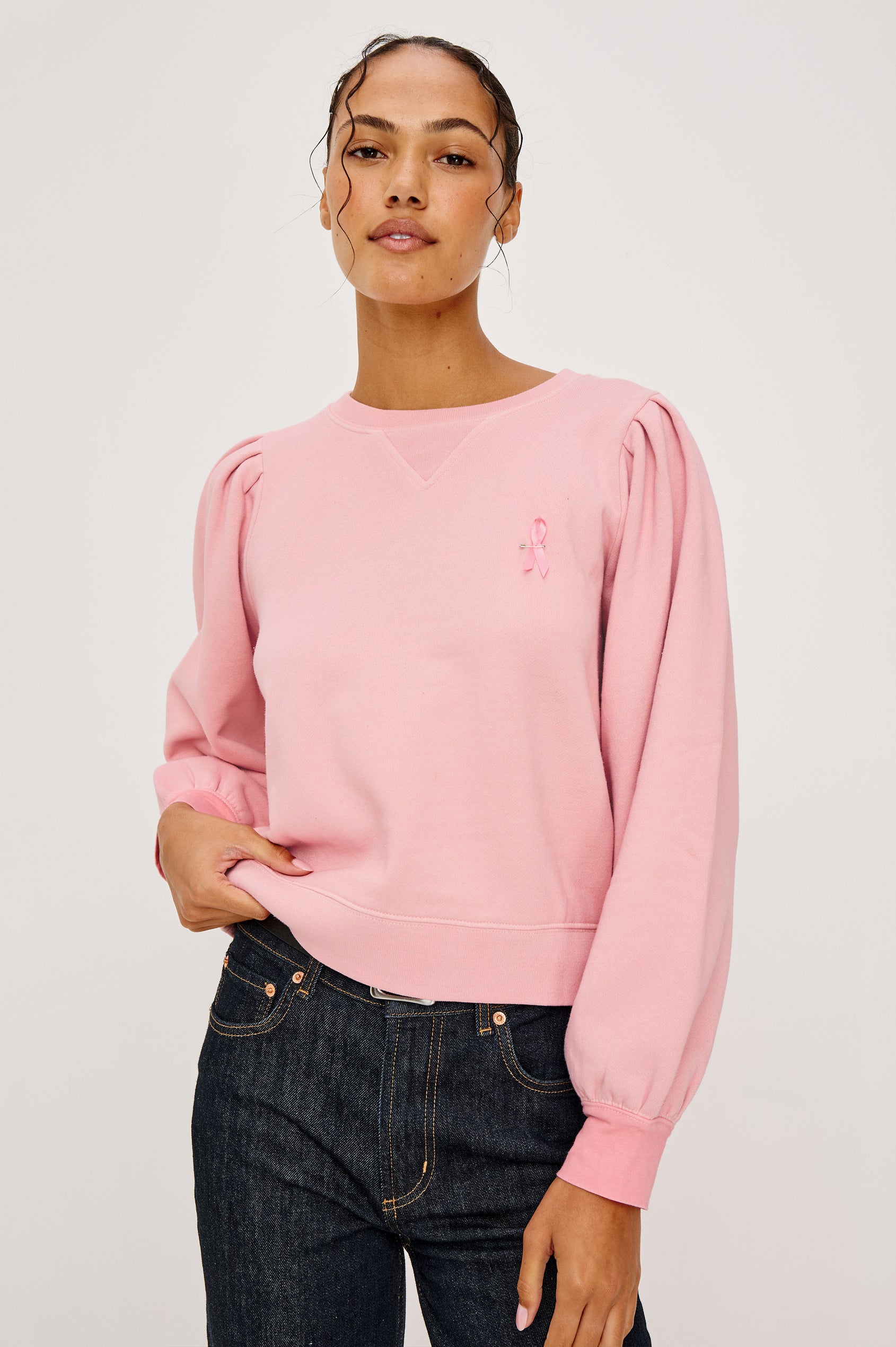Tiffany Long-Sleeve Sweatshirt with a Crew Neck and Deep Pleated Sleeves in Faded Brave Pink Colorway for Breast Cancer Awareness - Front View Featured on Model